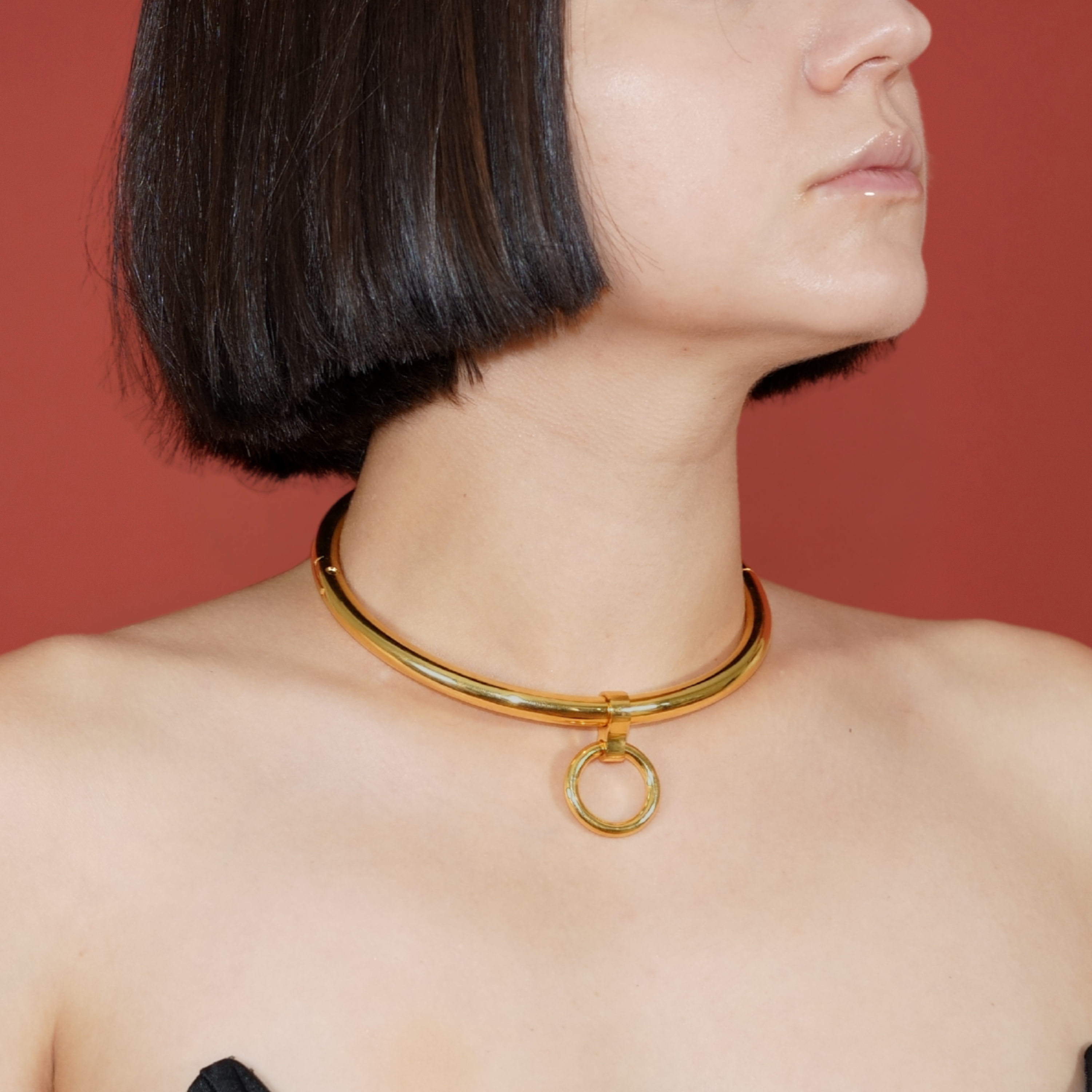deSade gold round day collar worn on a model's neck