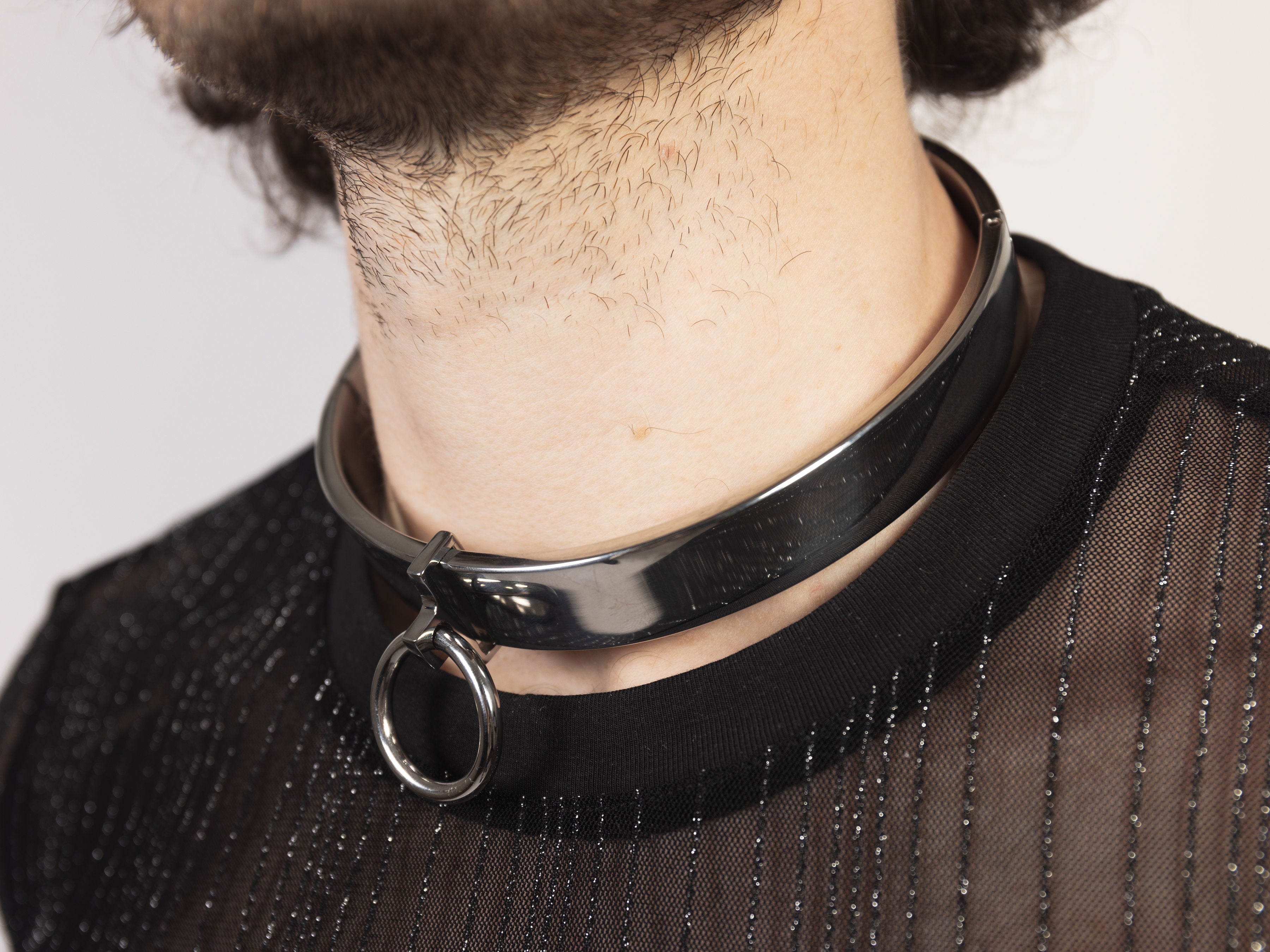 deSade silver flat collar worn on a model's neck with the front O-ring