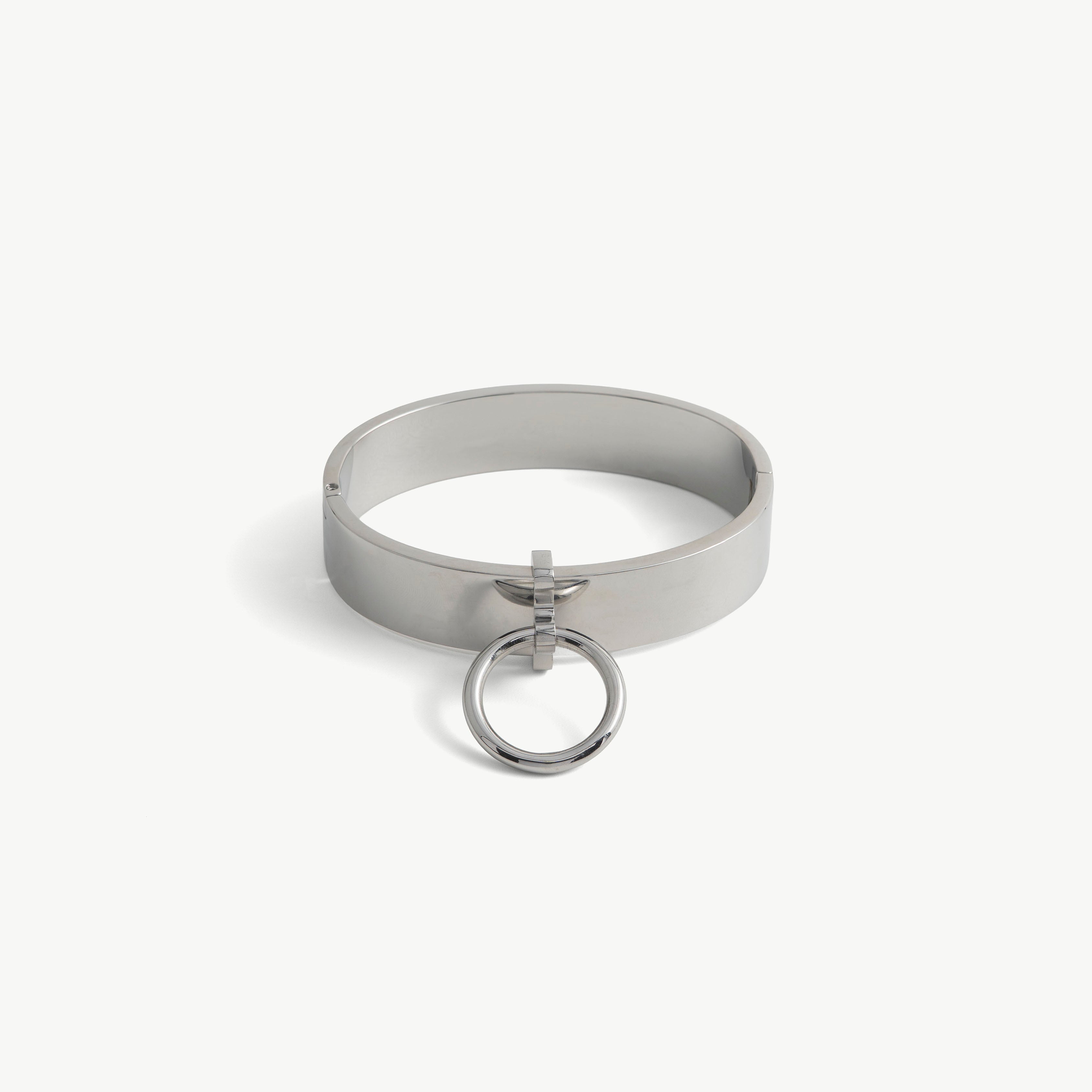 Polished steel deSade ankle band with a hanging O-ring, angled view