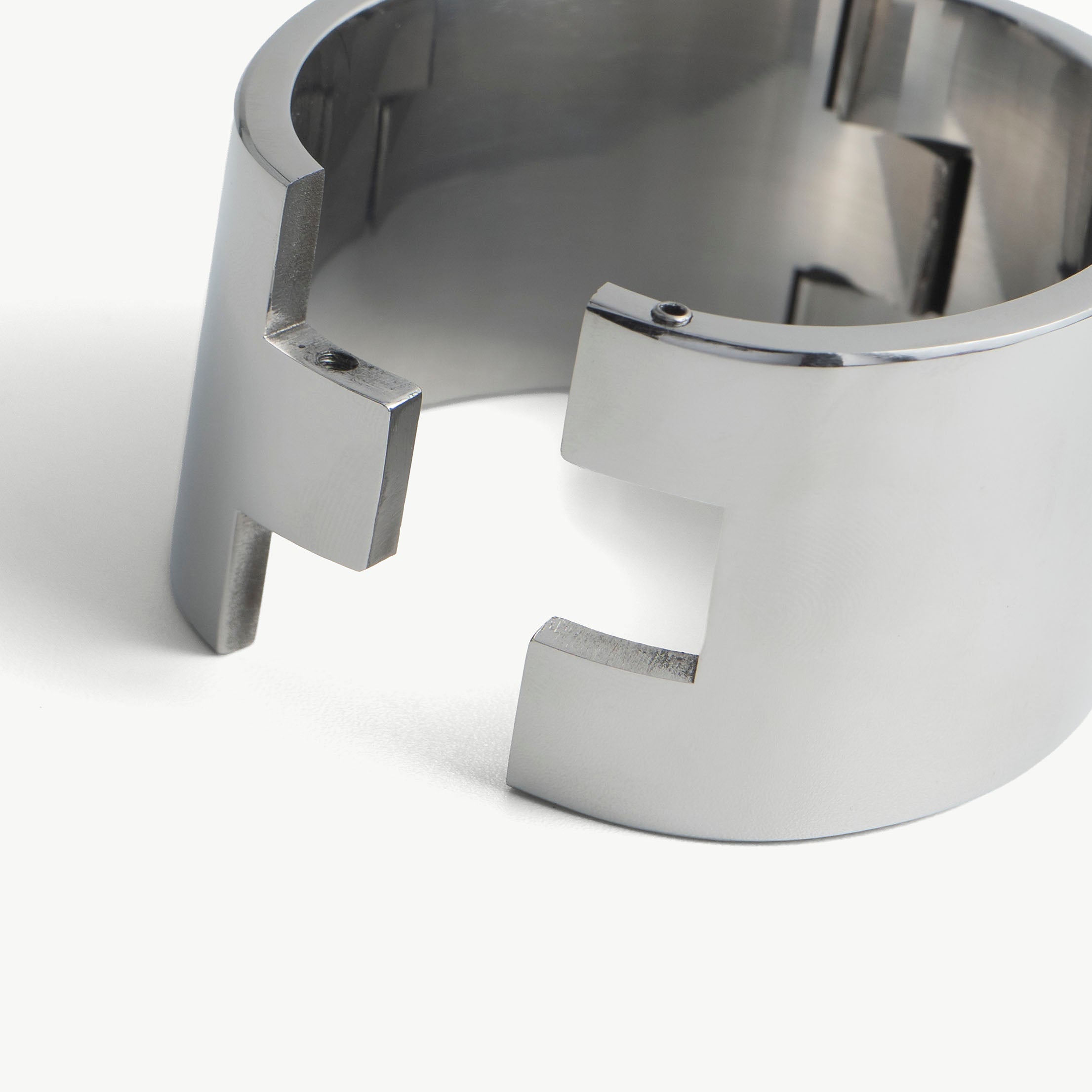 Close-up of the deSade wrist band open hinge ends with screw holes for the hex lock