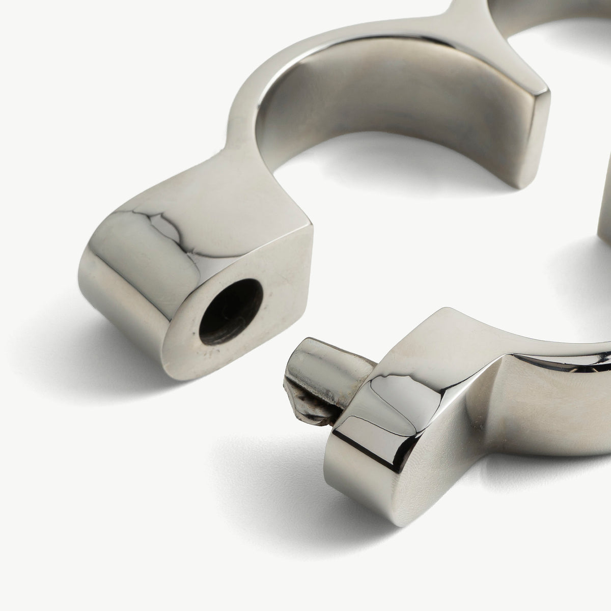 Close-up of the opened Irish 8 handcuffs showing the locking bolt and socket