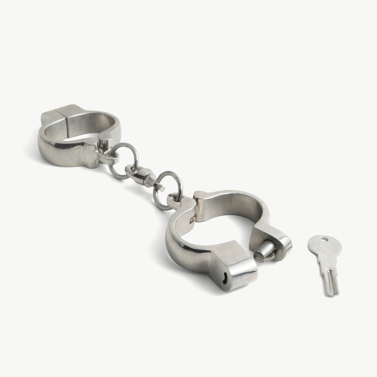 Hamburg-8 handcuffs shown open with their key, polished steel with click closure