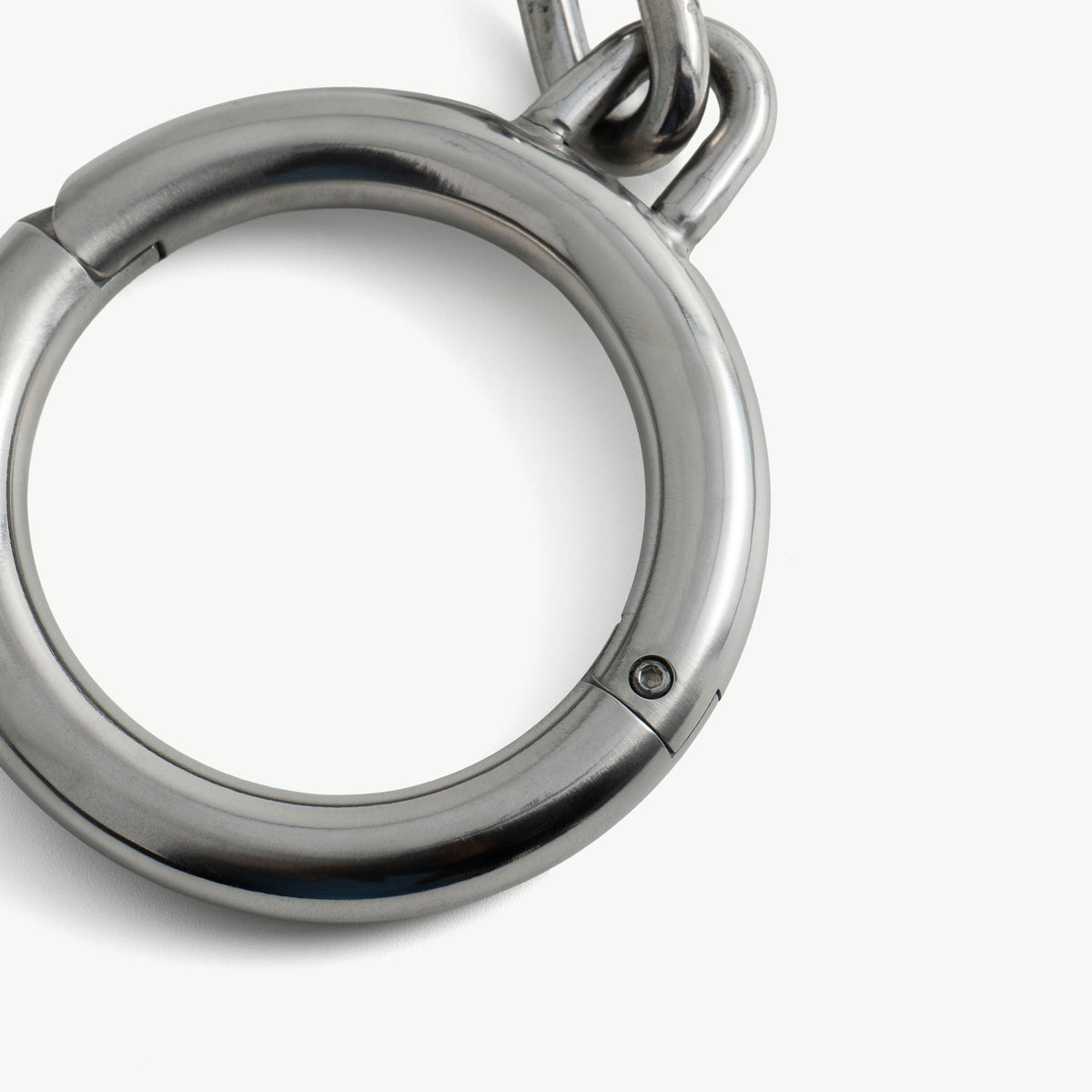 Close-up of a super heavy legcuff ring with lock screw and chain link