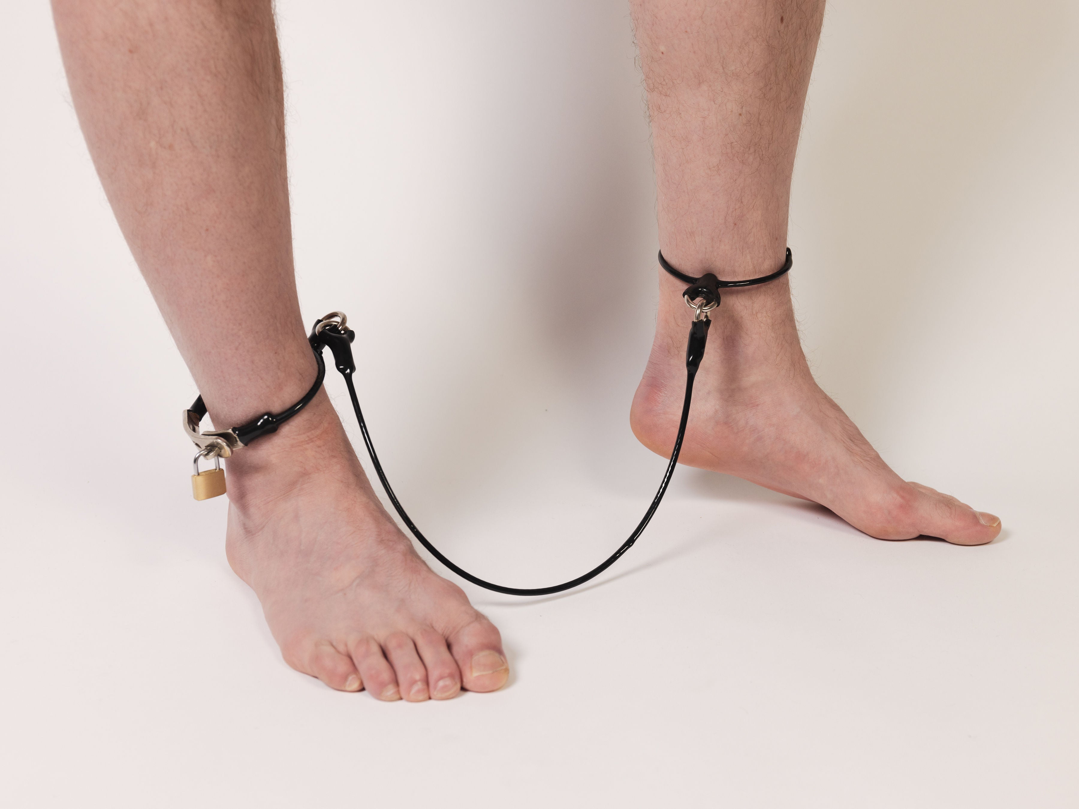 Cable legcuffs - adjustable, coated steel (black)
