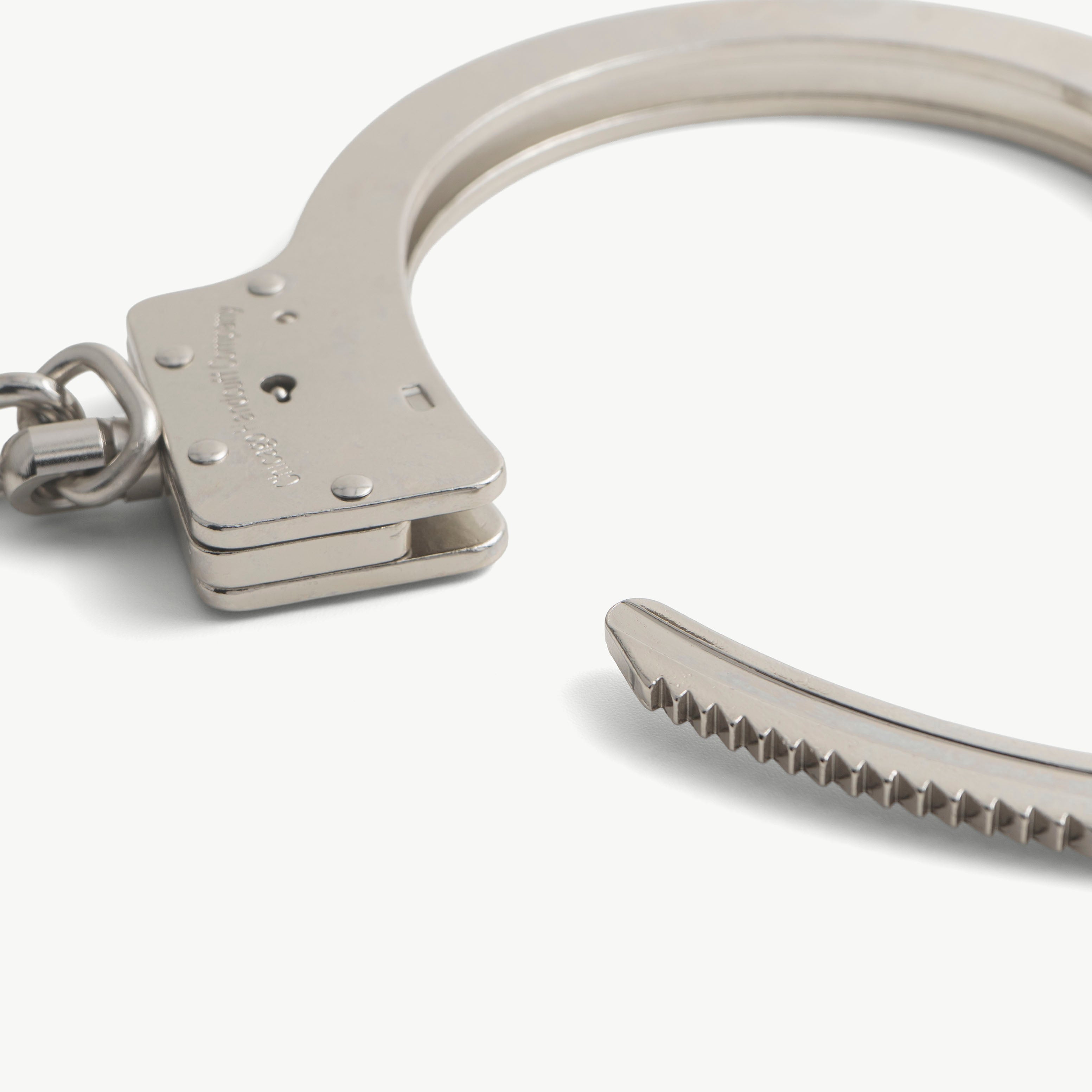 Open steel leg iron bow showing single-strand ratchet teeth and locking block