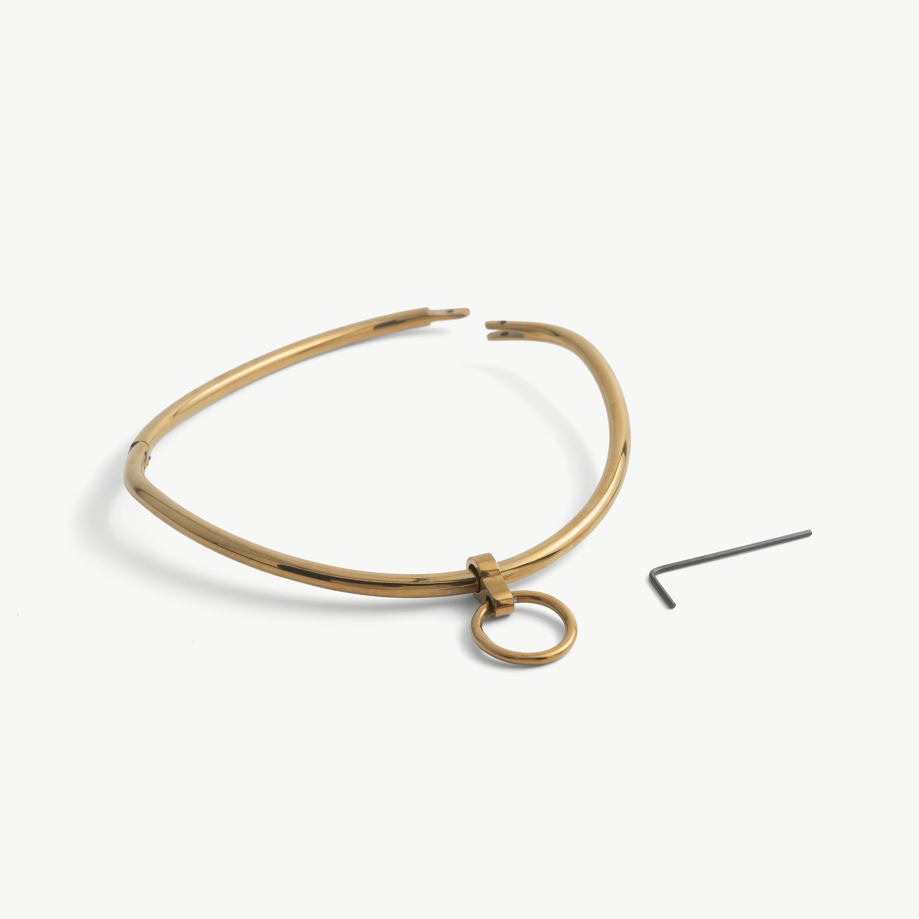 deSade gold day collar shown open beside its hex key