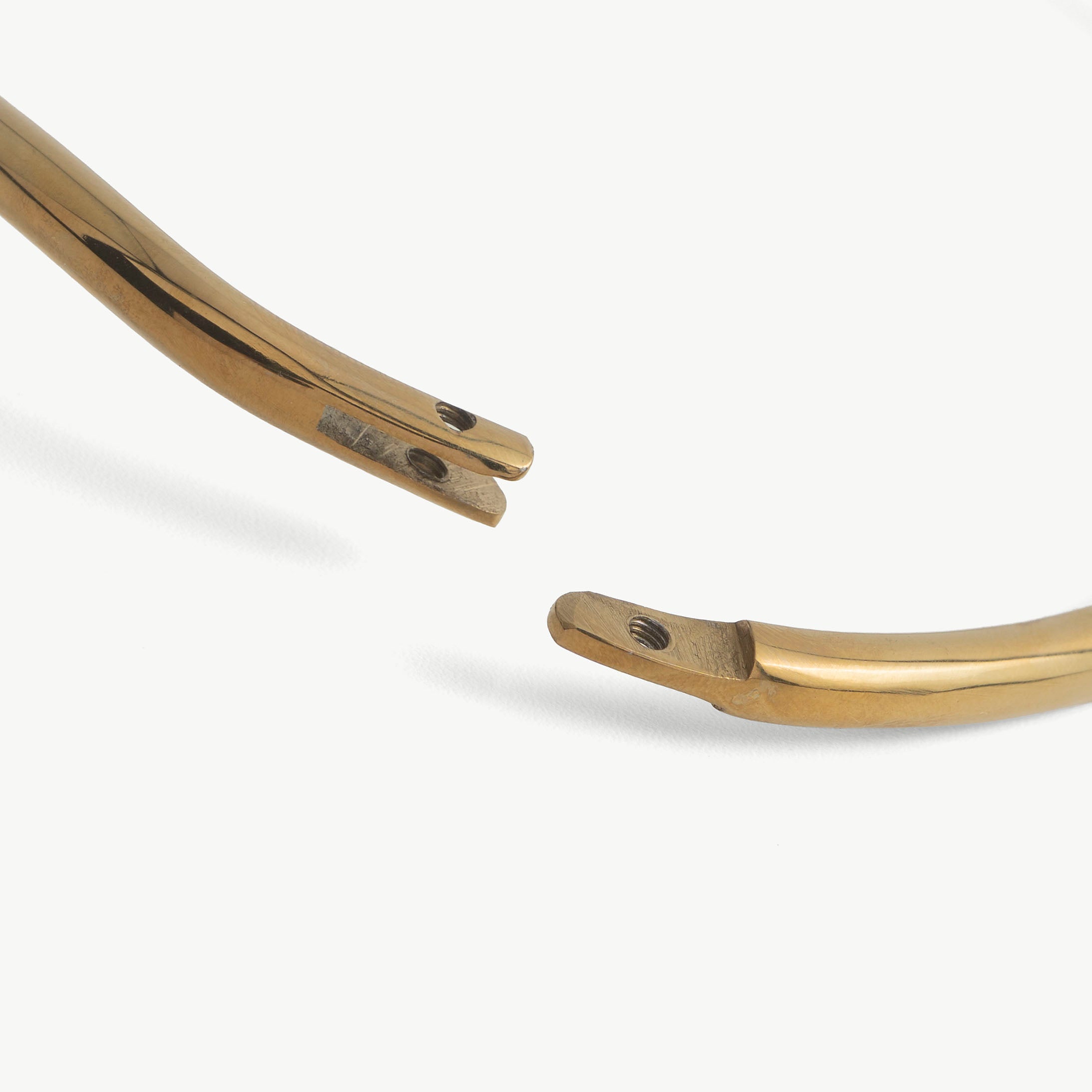 Close-up of the deSade collar's hex lock opening at the polished ends