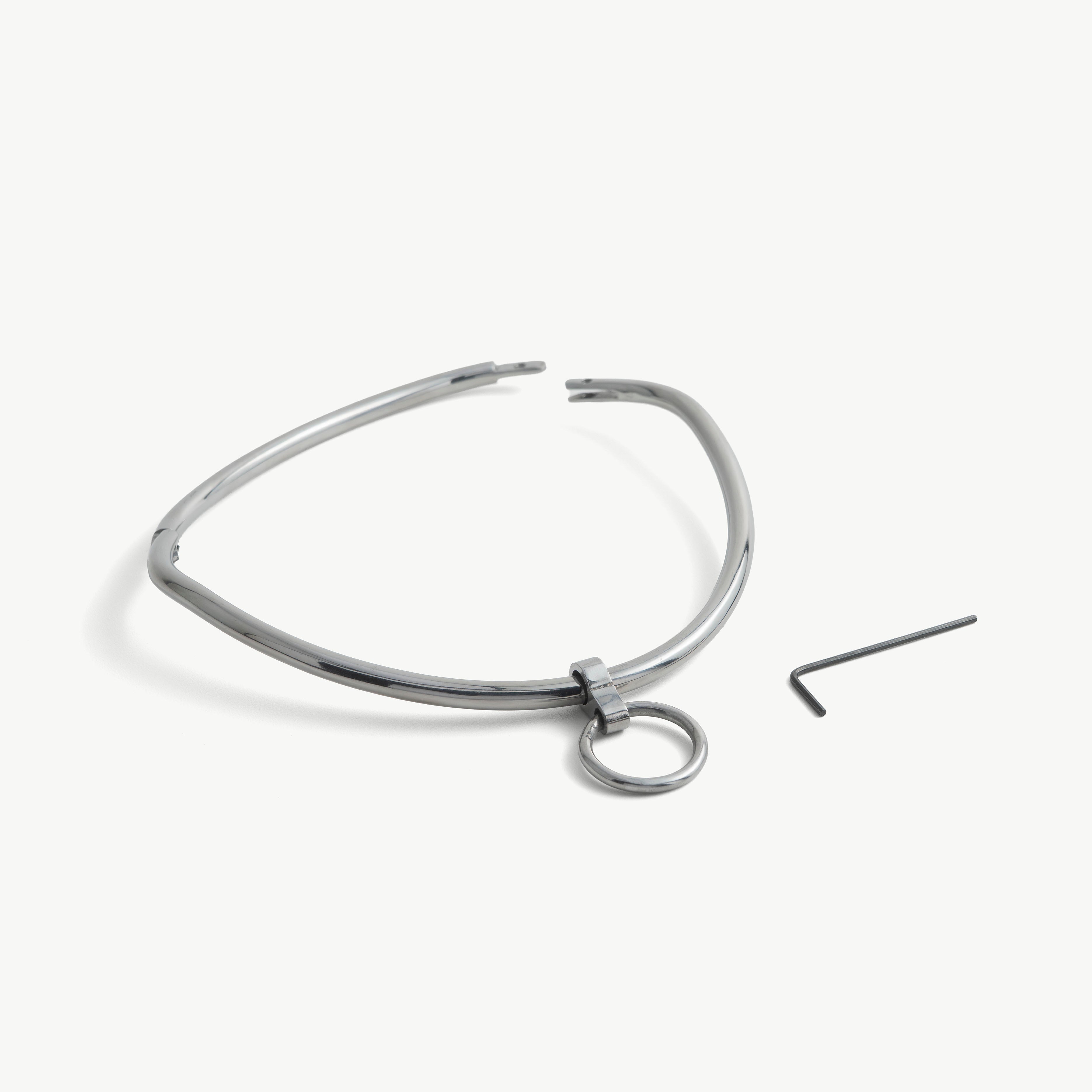deSade silver day collar shown open beside its hex key