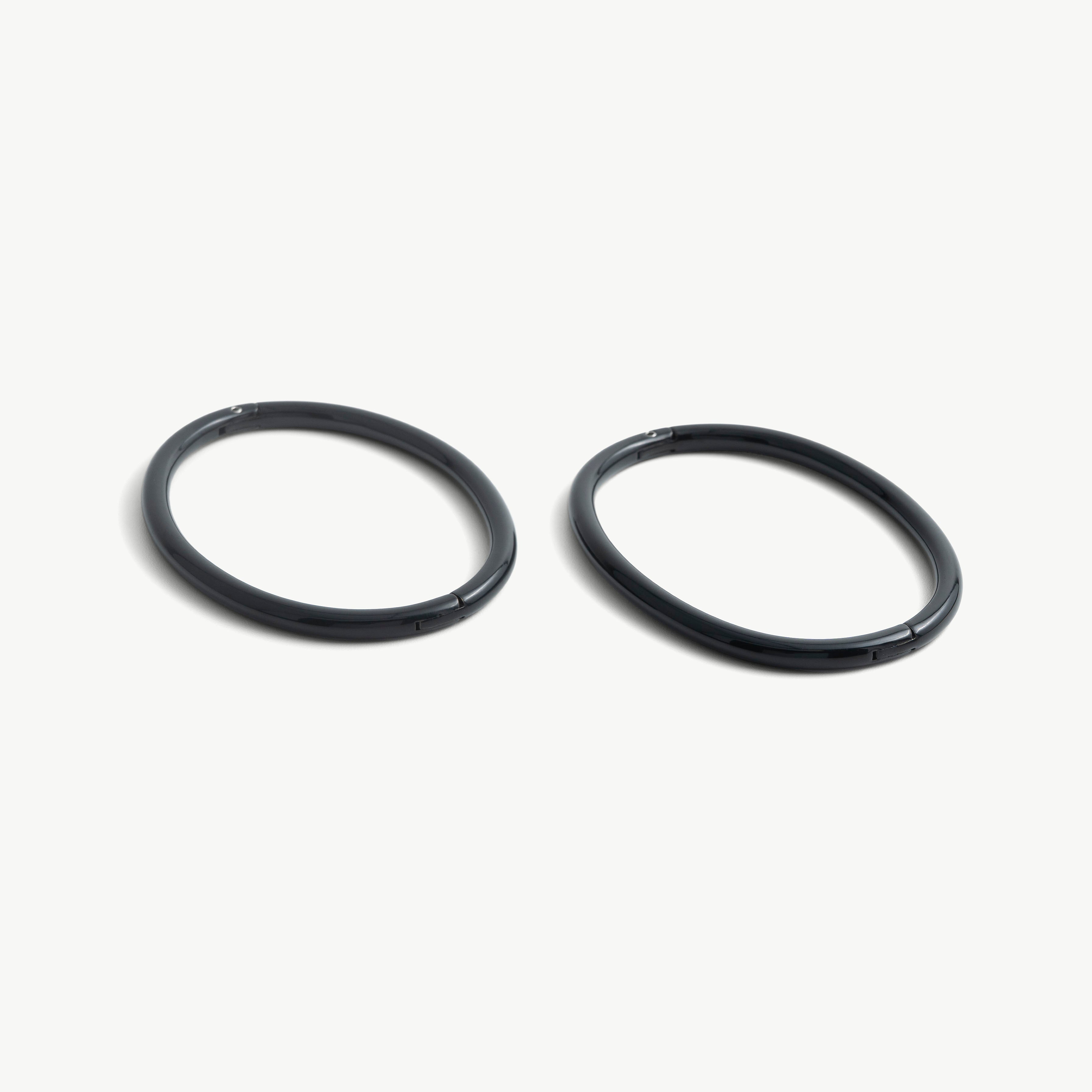 Pair of deSade black oval ankle bracelets shown together in 6mm steel
