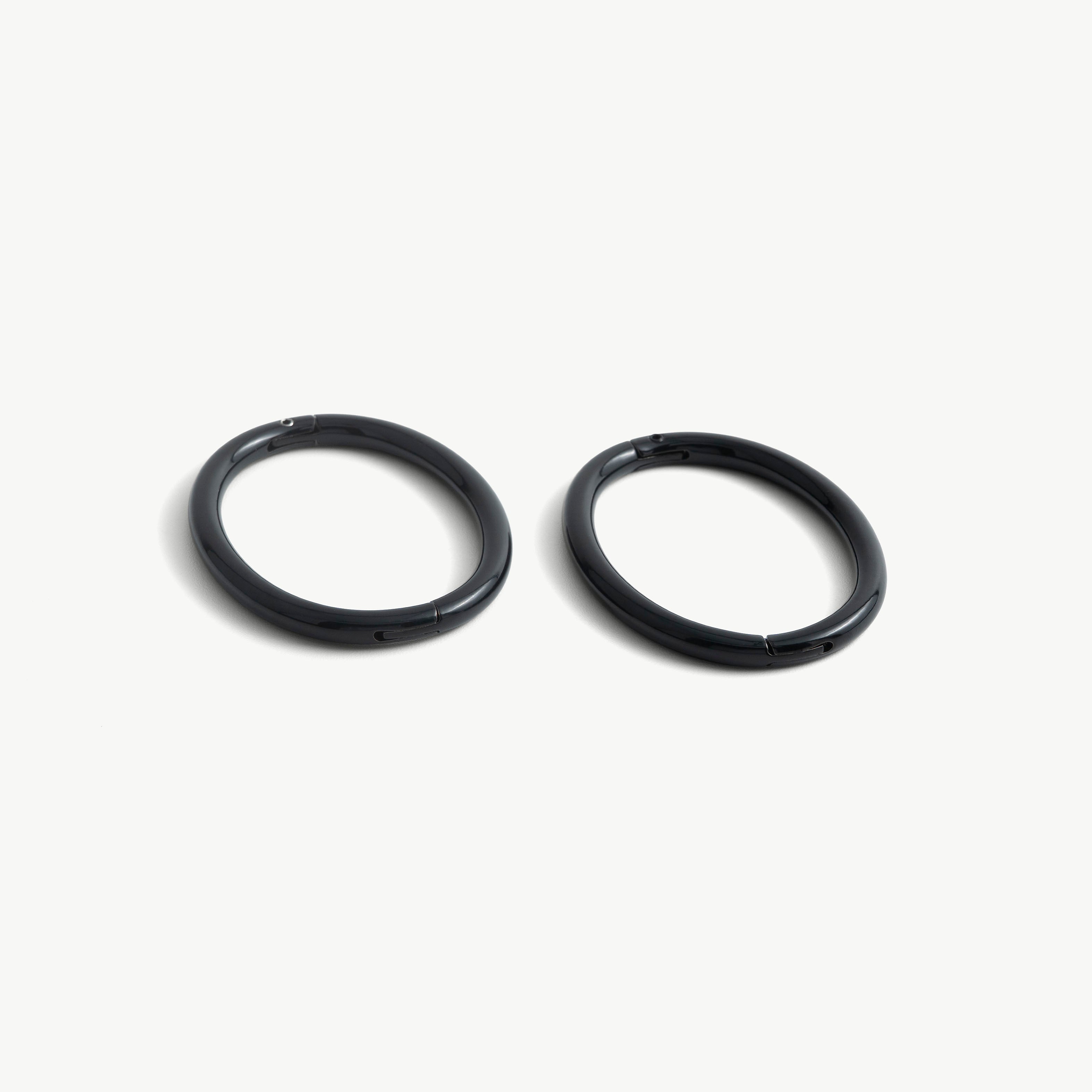 Pair of deSade black oval wrist bracelets shown together in 6mm steel