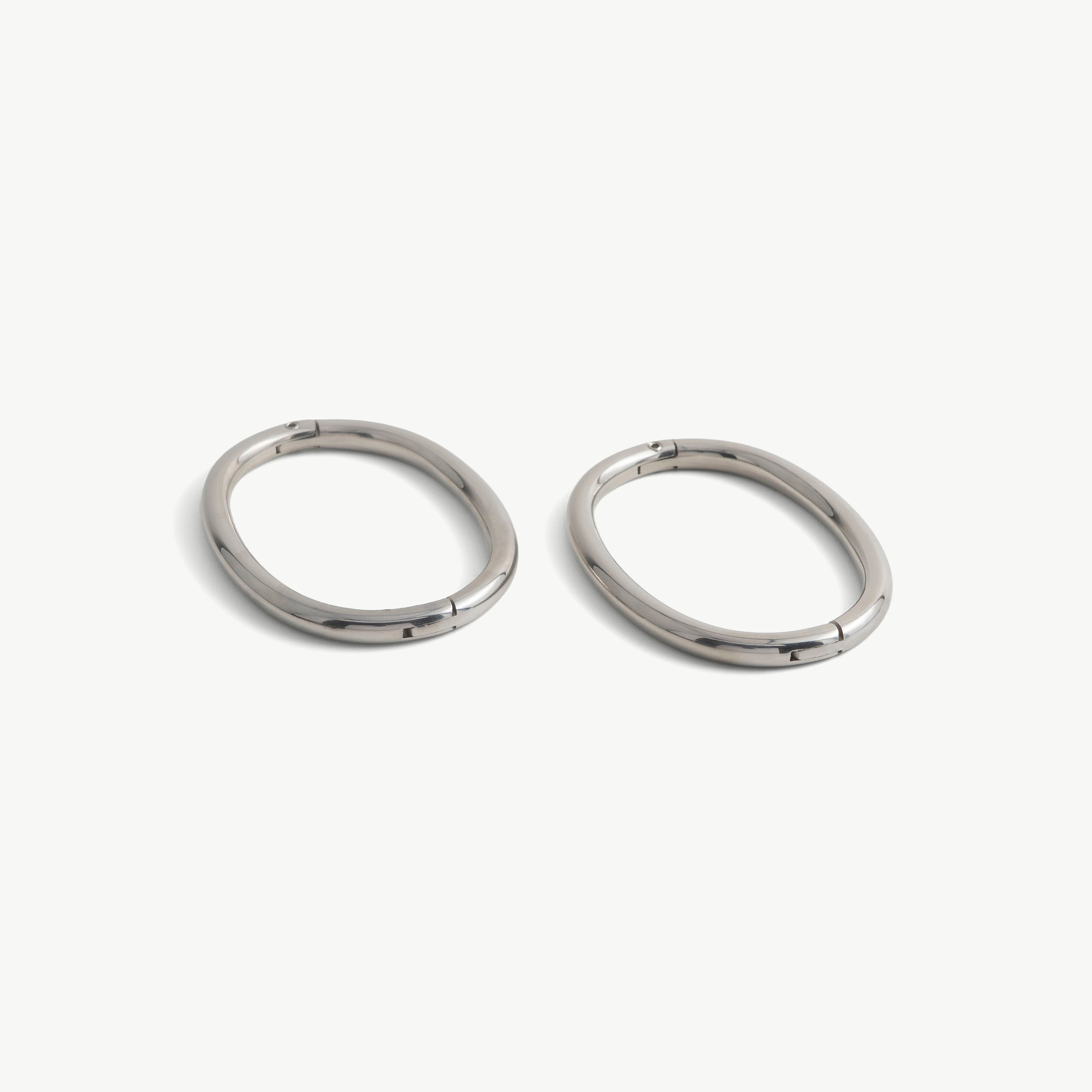Pair of deSade silver oval wrist bracelets shown together in 6mm steel