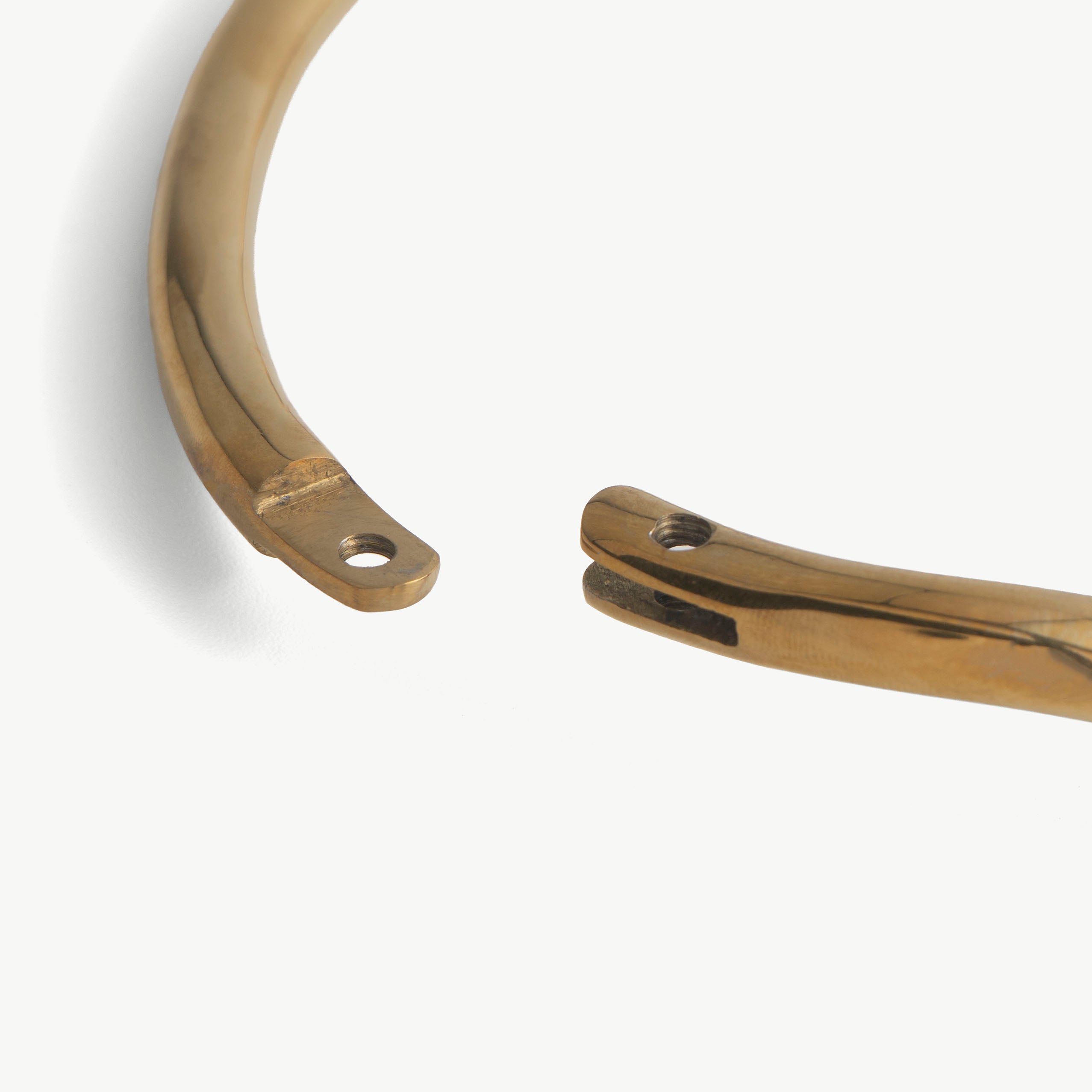 Close-up of the deSade collar's hex lock opening with screw holes at the polished ends