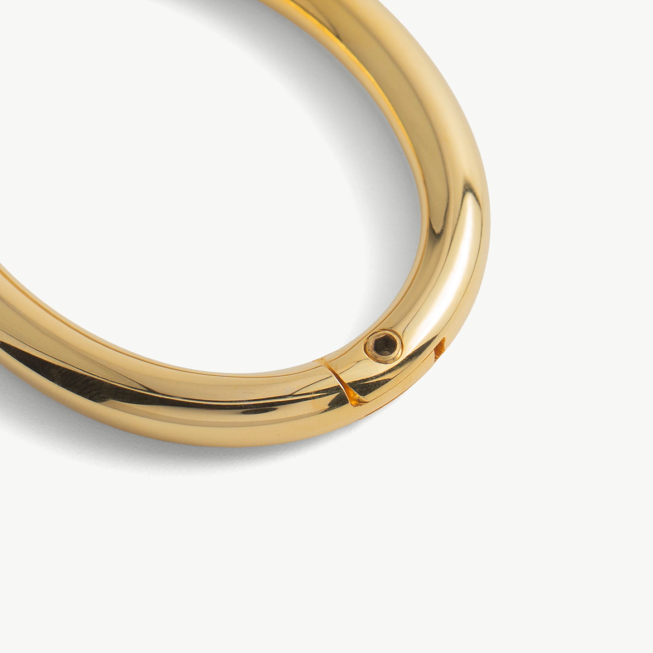Close-up of the hidden hex lock seam on the gold deSade wrist bracelet