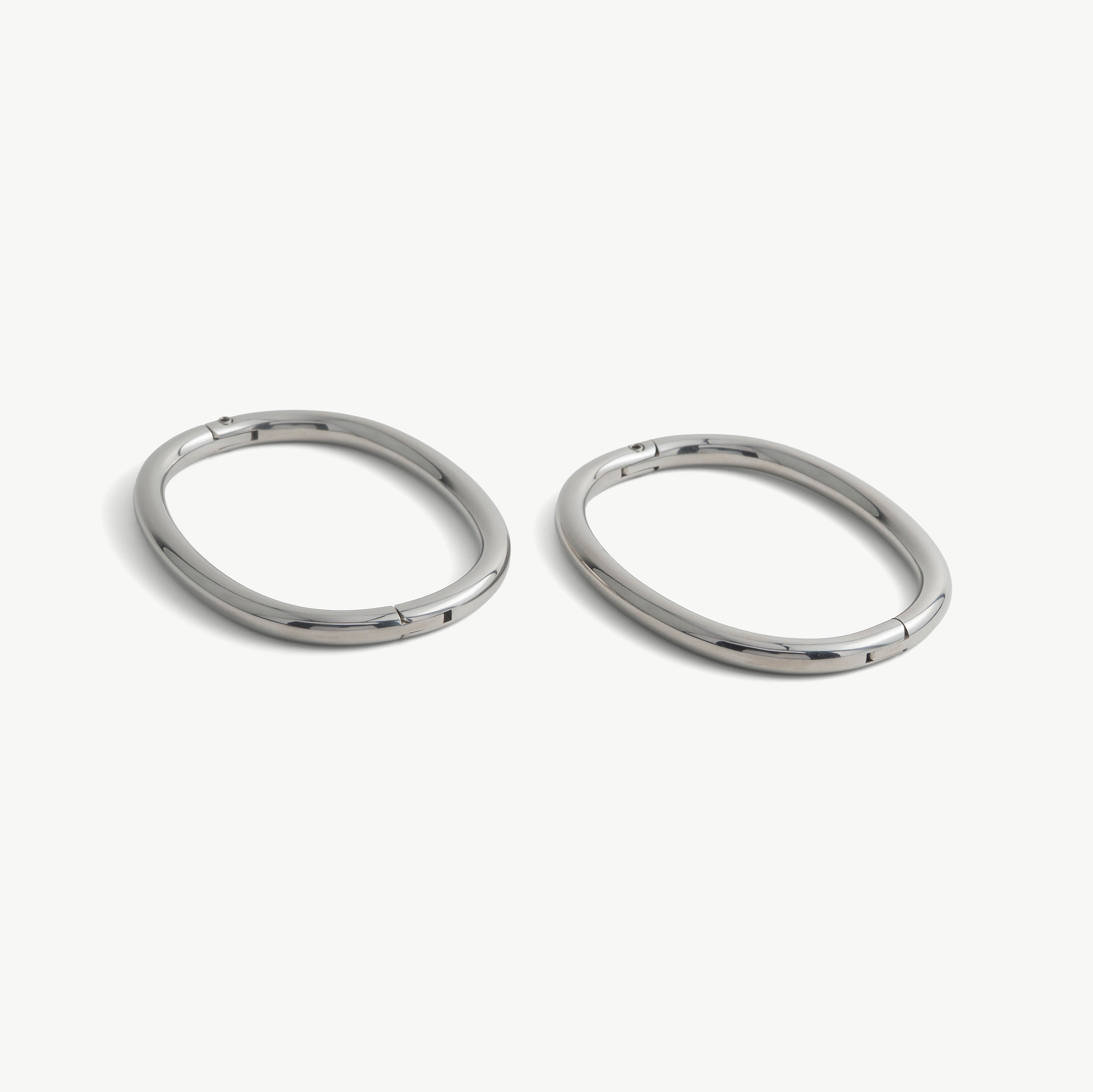 Pair of deSade silver oval ankle bracelets shown together in 8mm steel