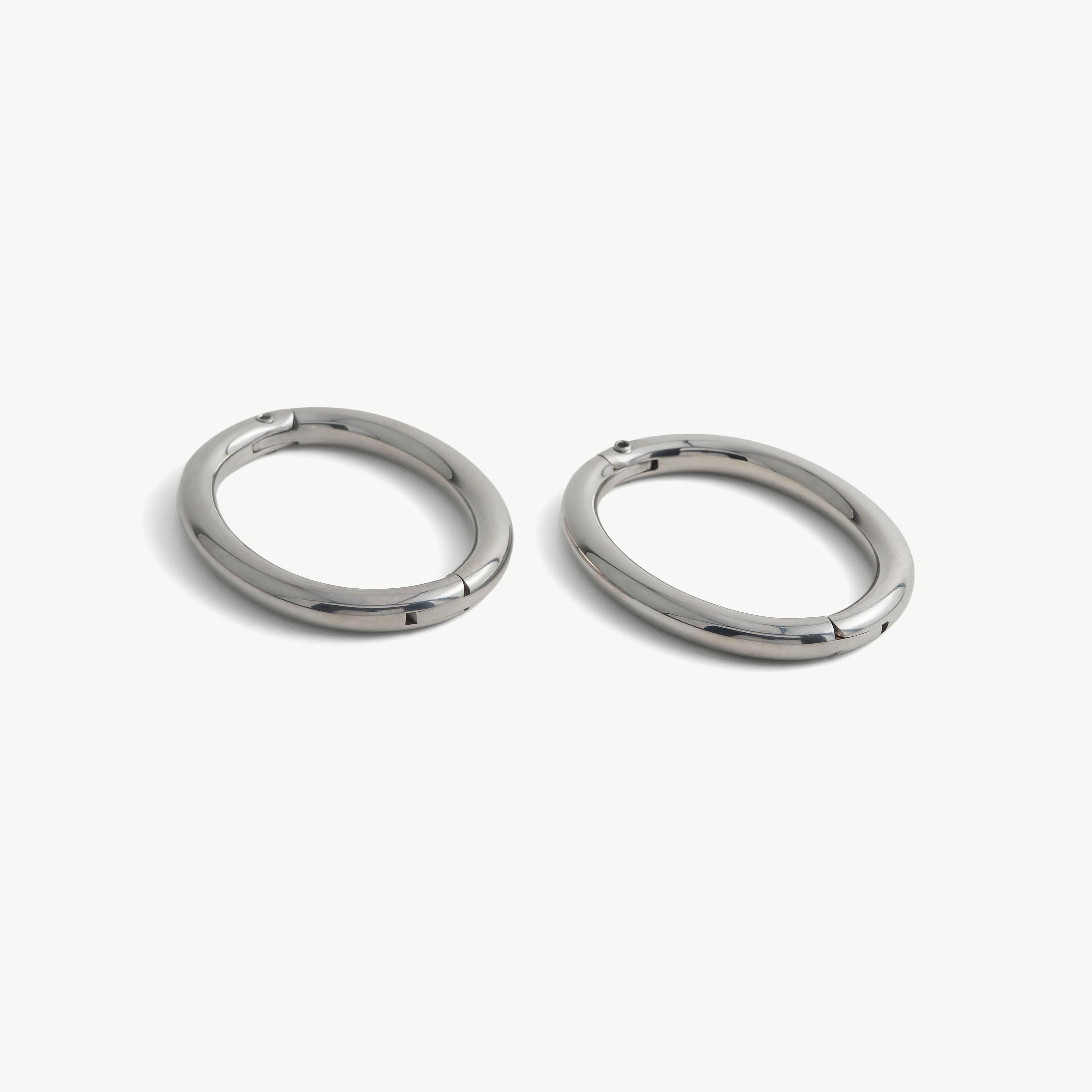 Pair of deSade silver oval wrist bracelets shown together in 8mm steel