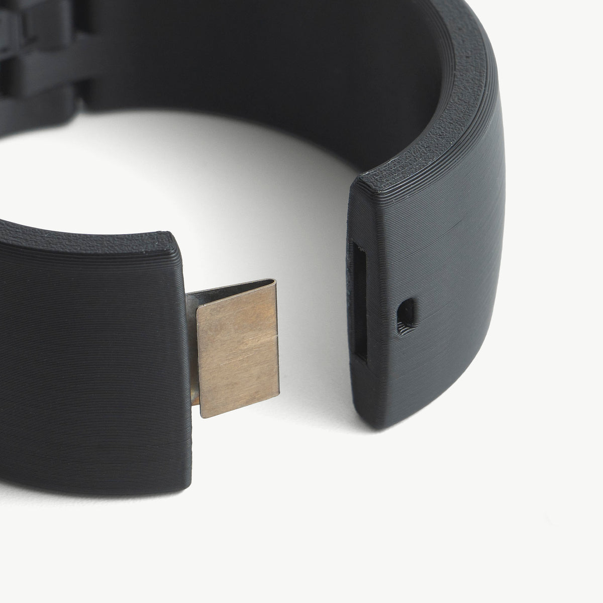 Close-up of the open Quick Cuffs Adapt end with its steel locking tongue