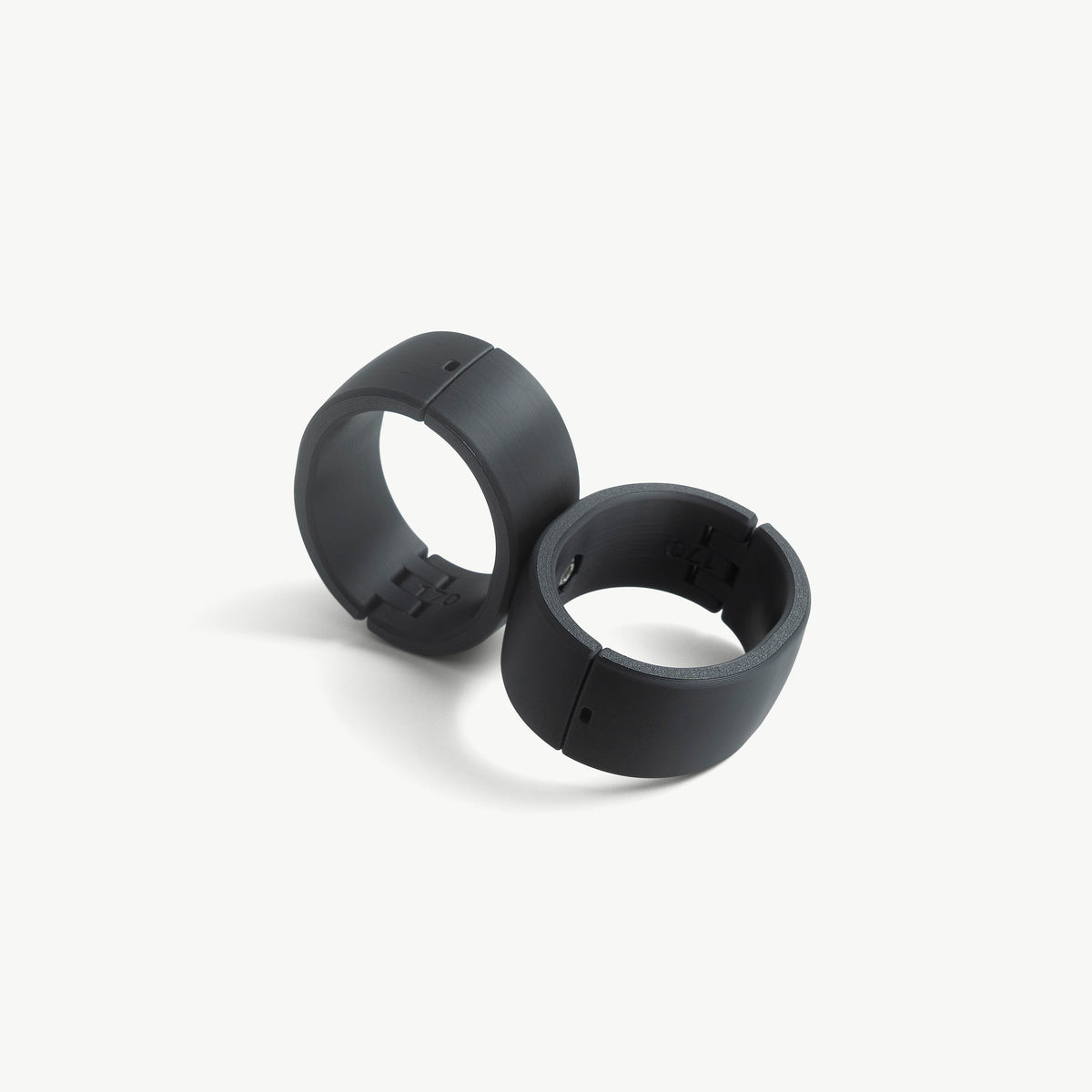 Black Quick Cuffs Adapt pair standing upright, angled view