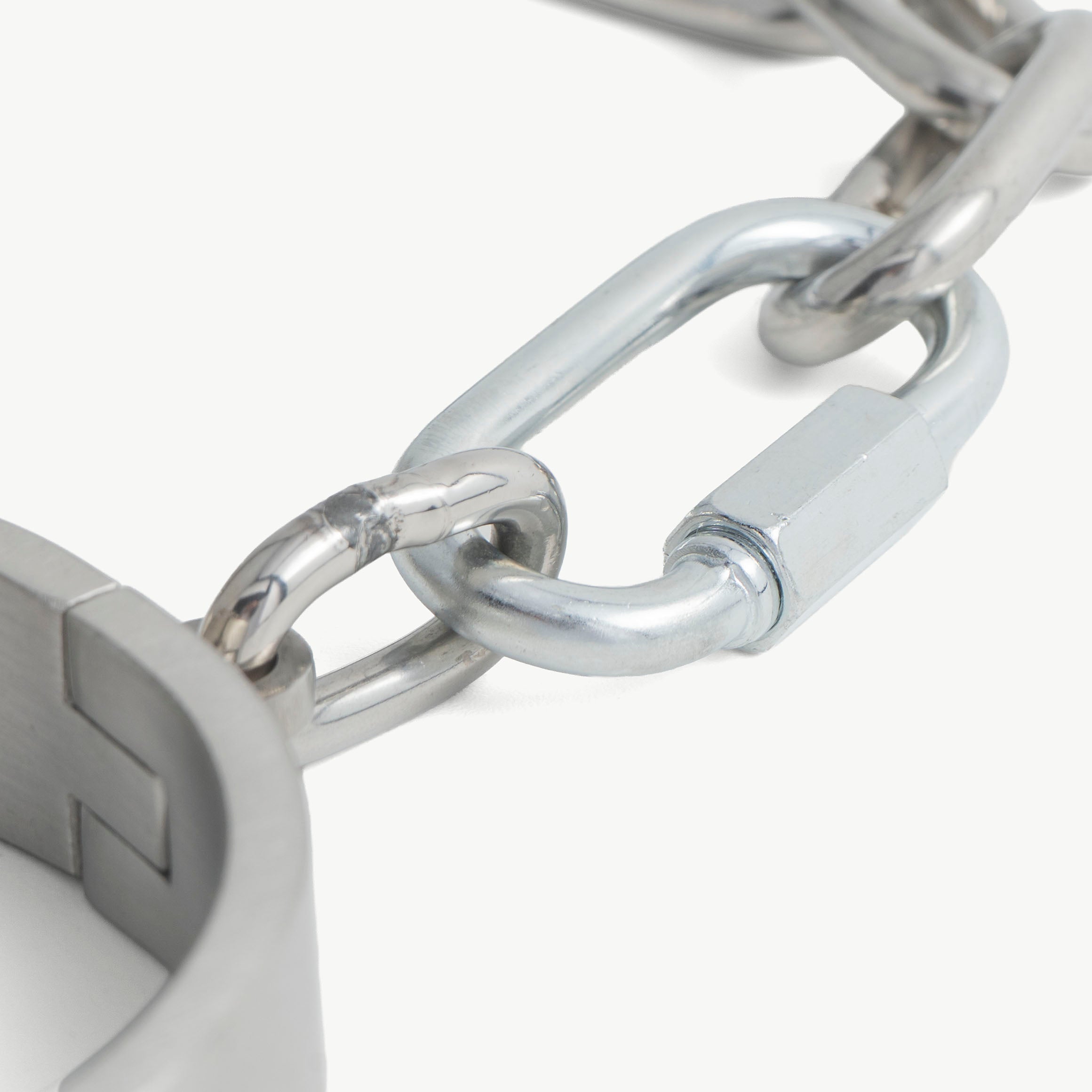 Close-up of the push-in lock on the brushed steel flat legcuffs