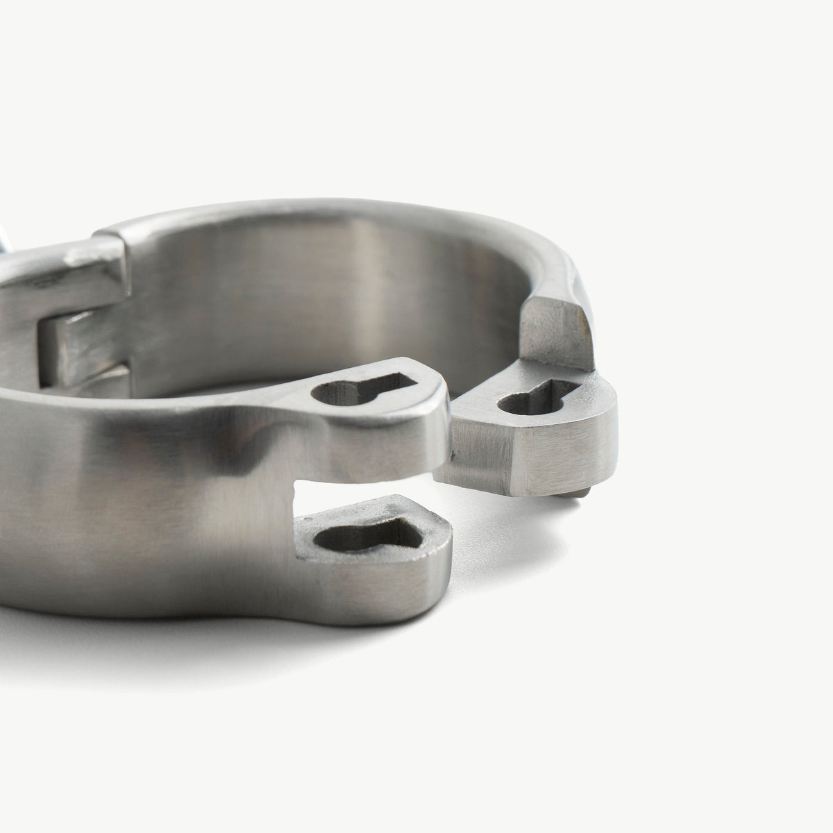 Close-up of the rounded handcuff's open hinge ends and lock slots