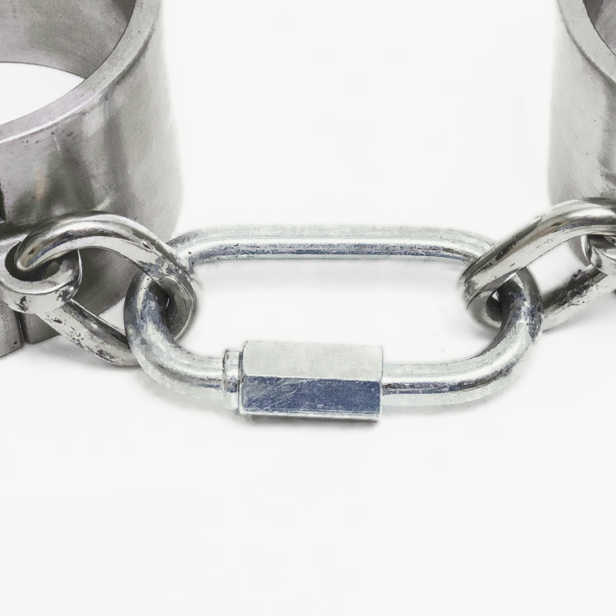 Close-up of the screw-link connector and chain between the massive cuffs