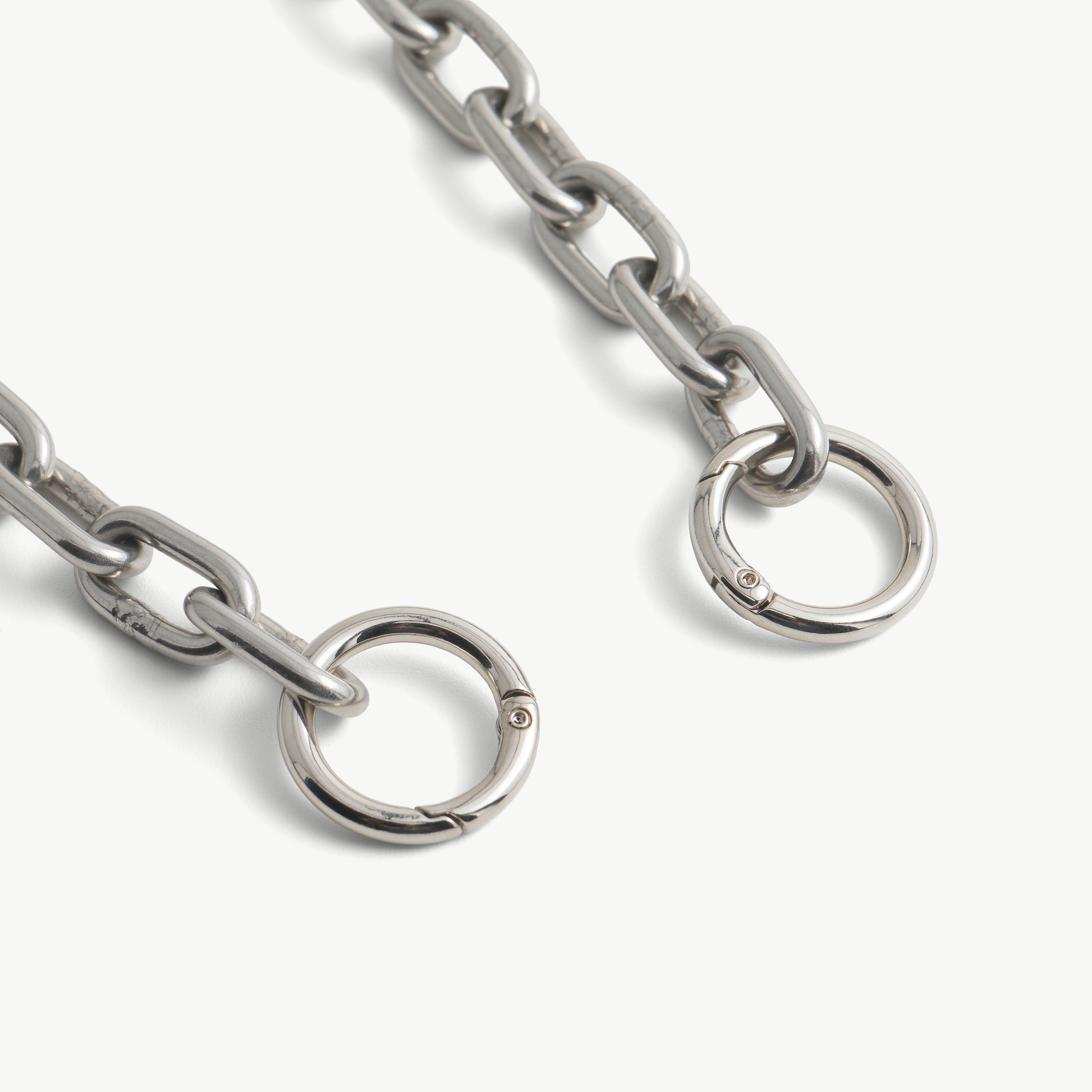 Close-up of the two spring-gate O-ring clasps on the steel choker chain