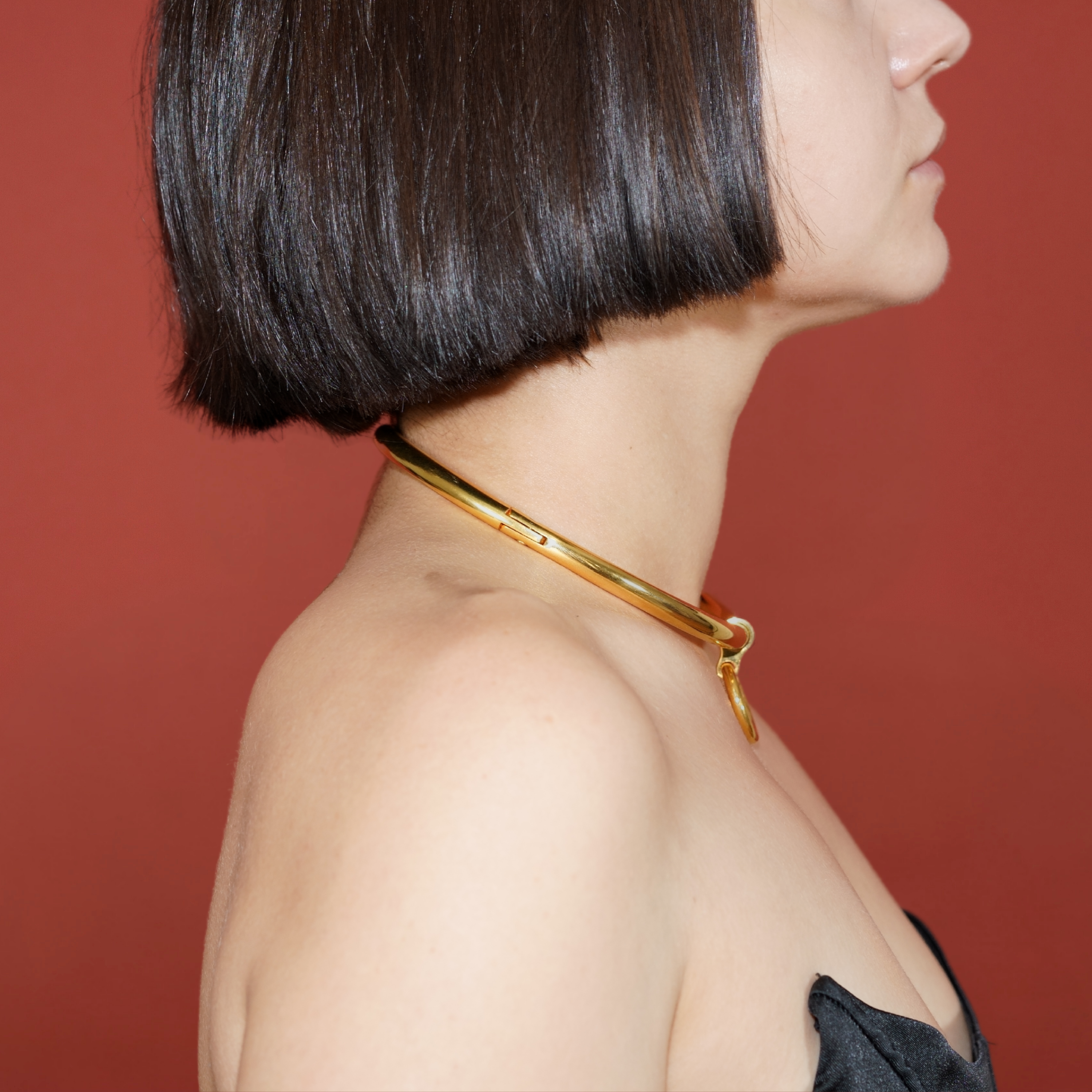 deSade gold round day collar worn on a model's neck, alternate view