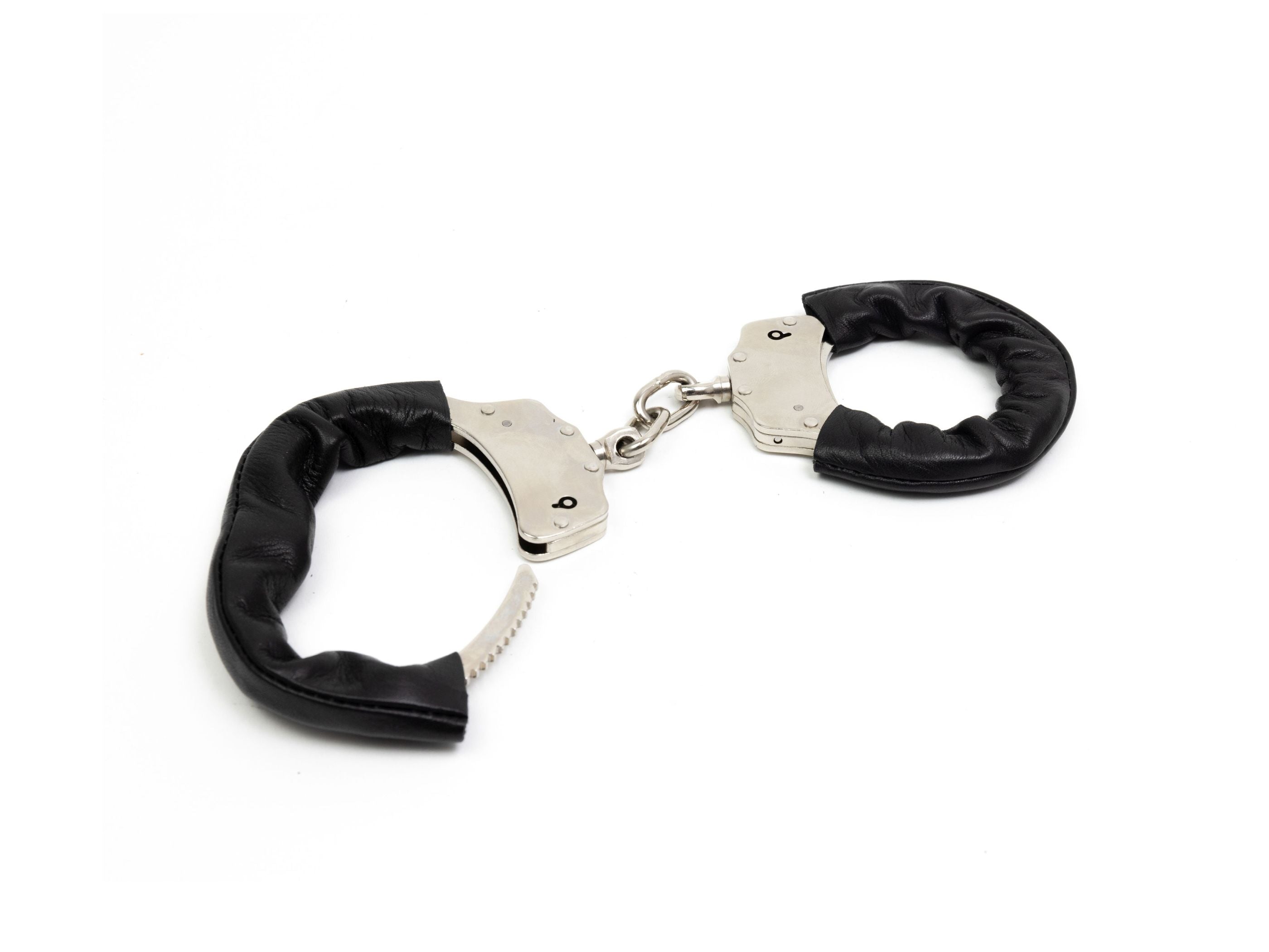 Black leather wrist protector on a handcuff, angled view