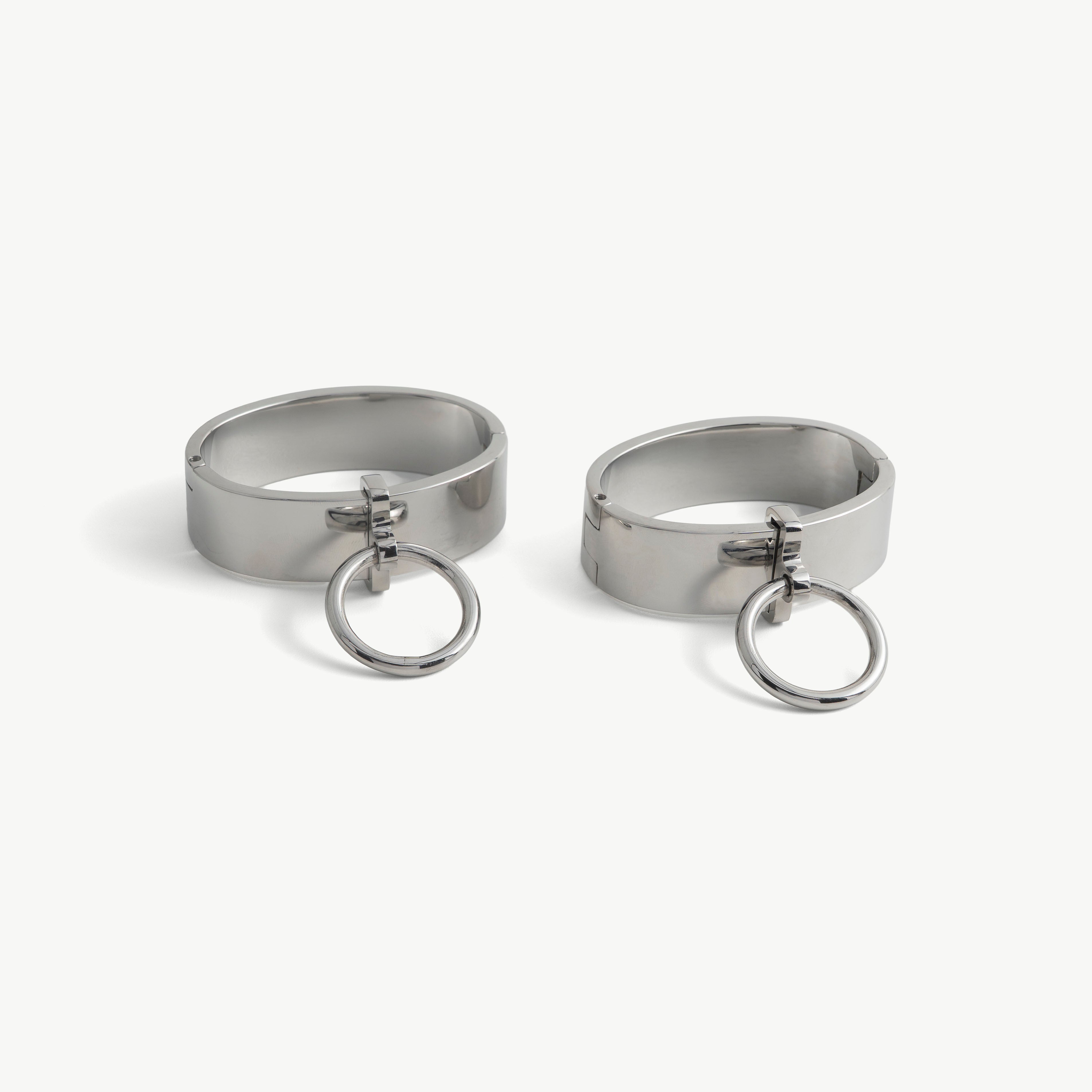 Pair of deSade silver wide wrist bracelets shown together