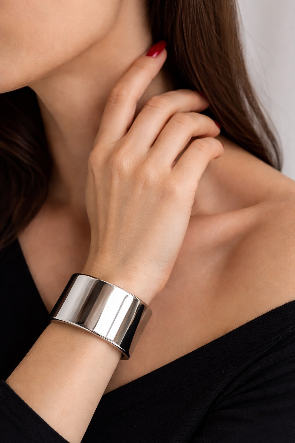 Polished steel deSade wrist band worn on a model's wrist