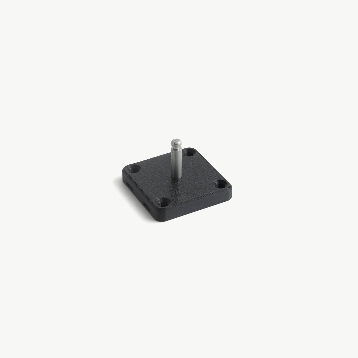 Black wall mount plate with a medical lock pin screwed into its central M6 thread