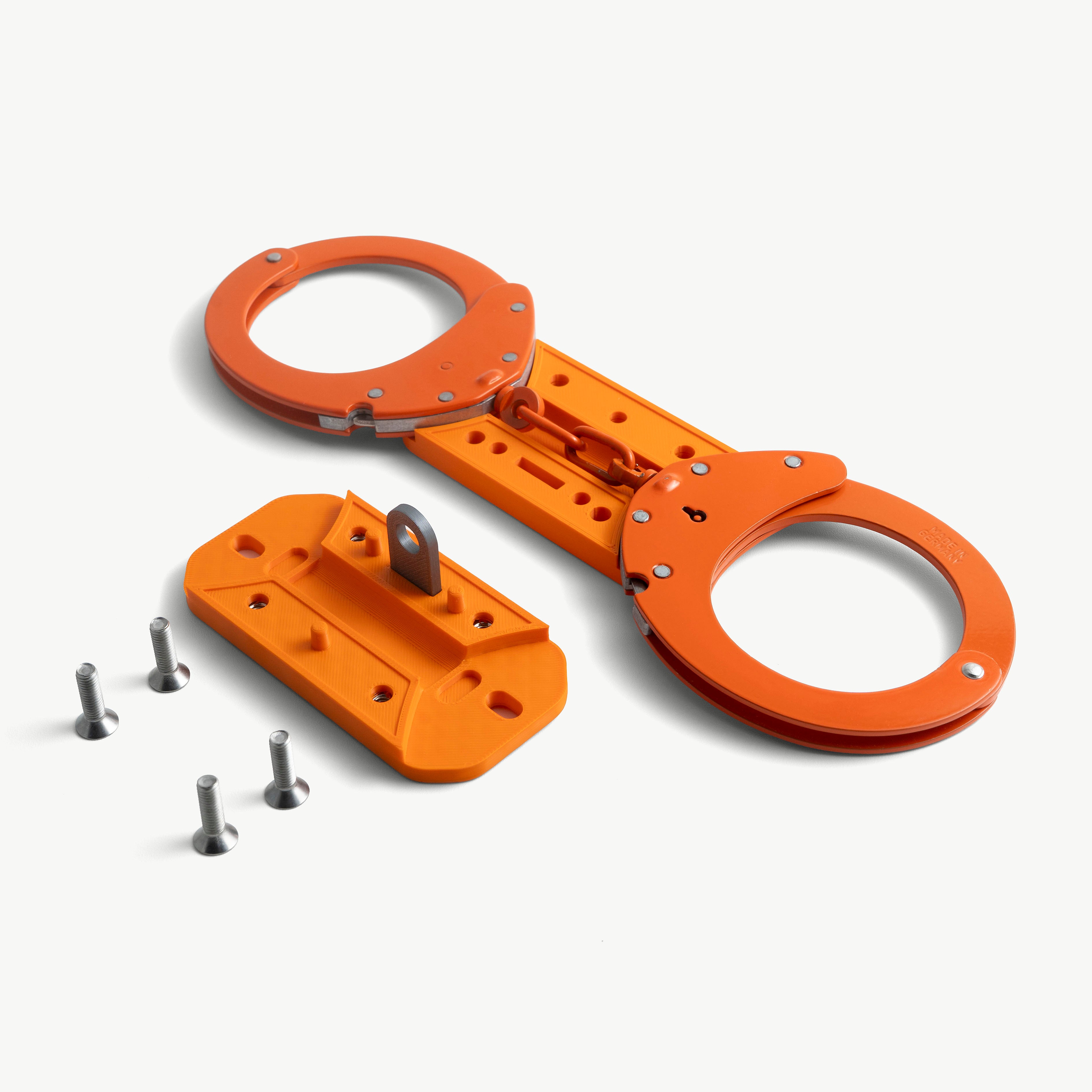 Make-It-Rigid stiffener open with orange Clejuso 12A handcuffs laid into the lower housing