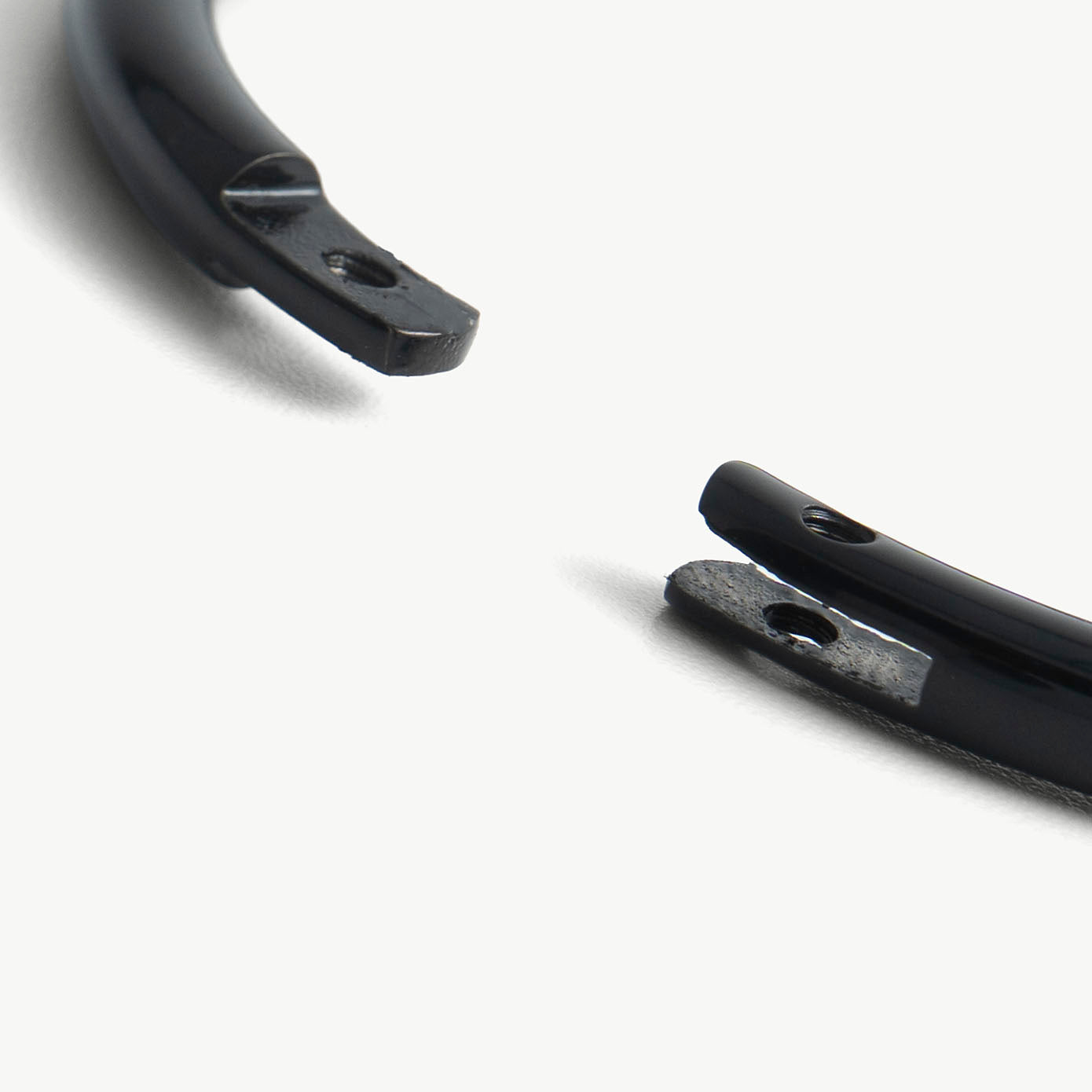 Extreme close-up of the deSade black bracelet's open ends and hex lock screw hole