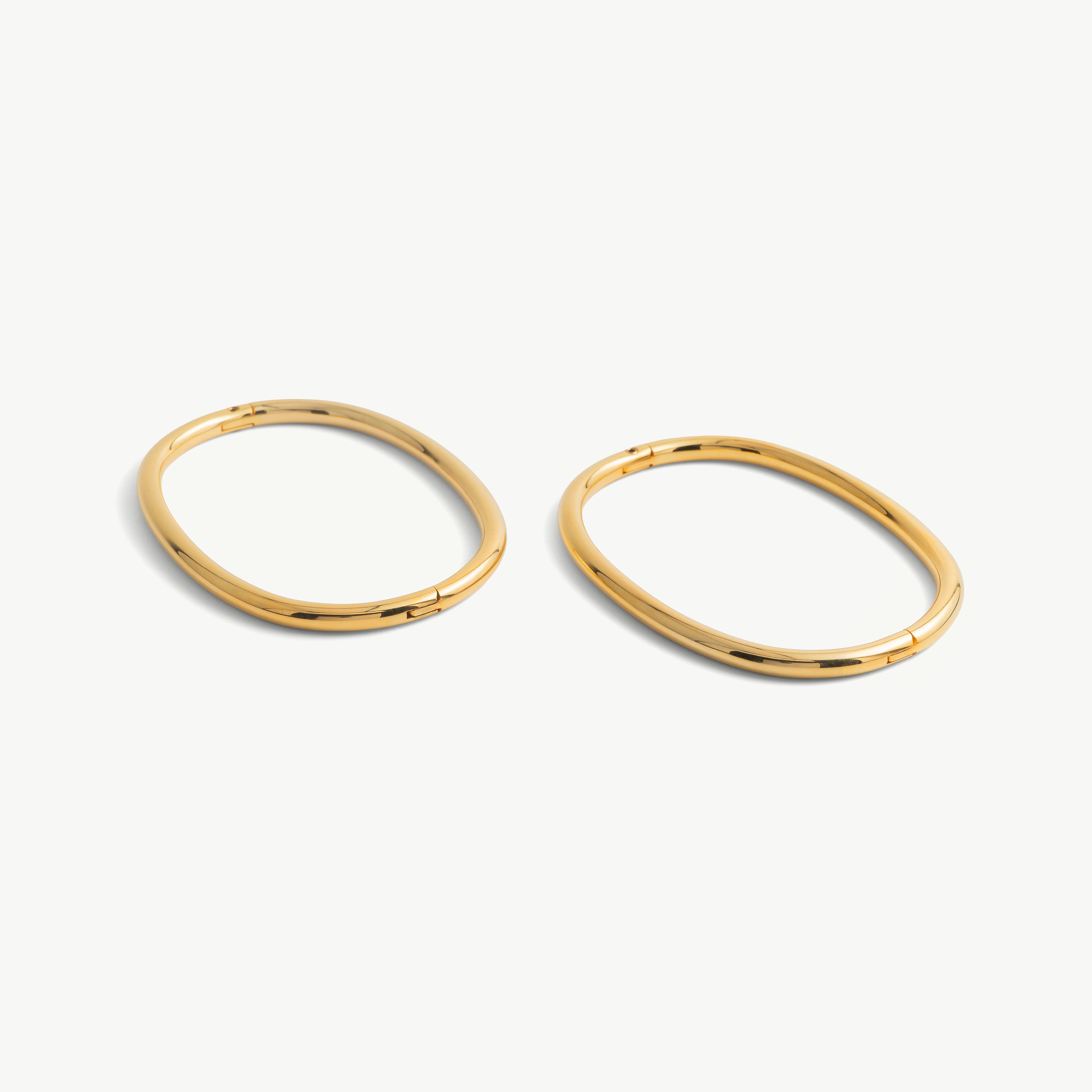 Pair of deSade gold oval ankle bracelets shown together in 6mm steel