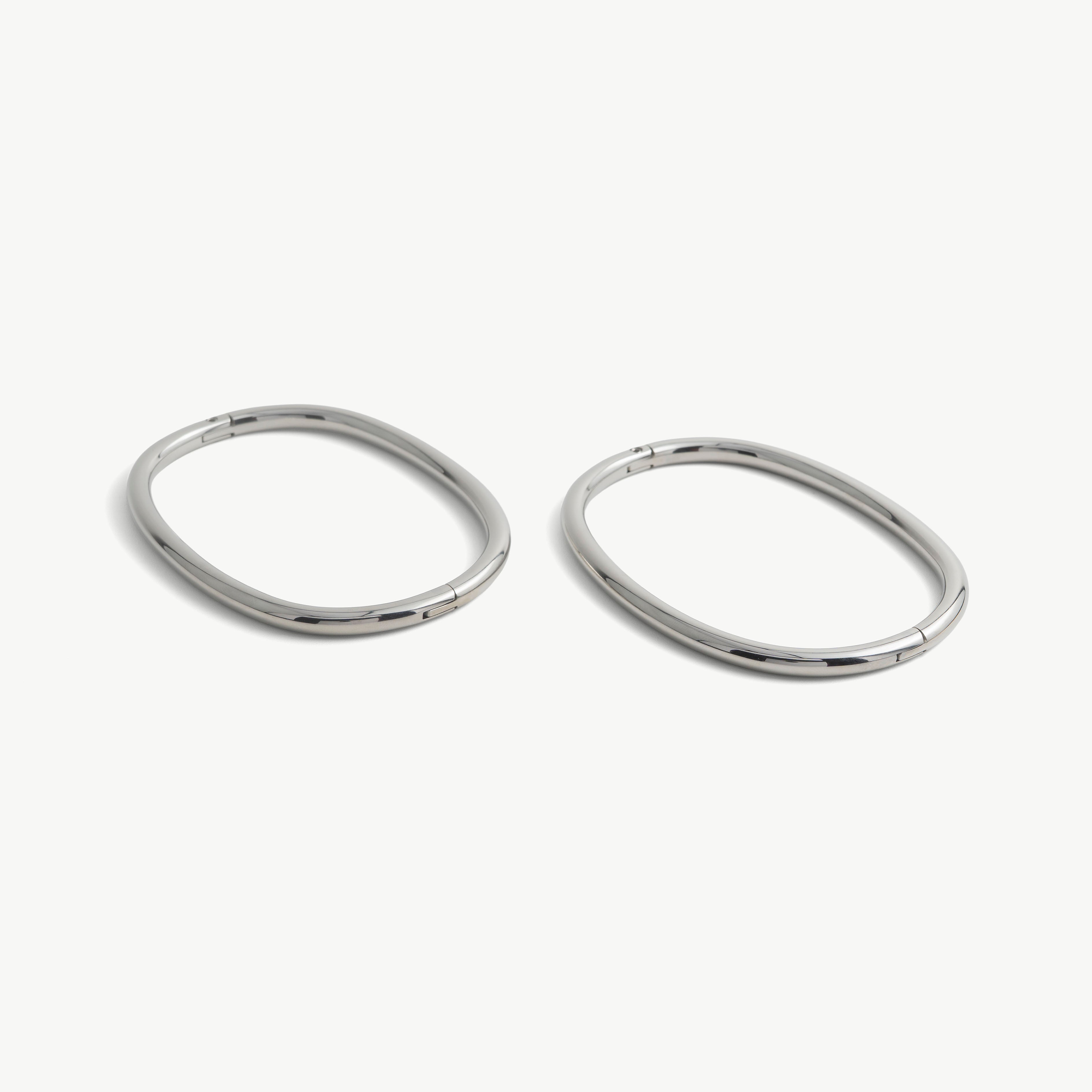Pair of deSade silver oval ankle bracelets shown together in 6mm steel