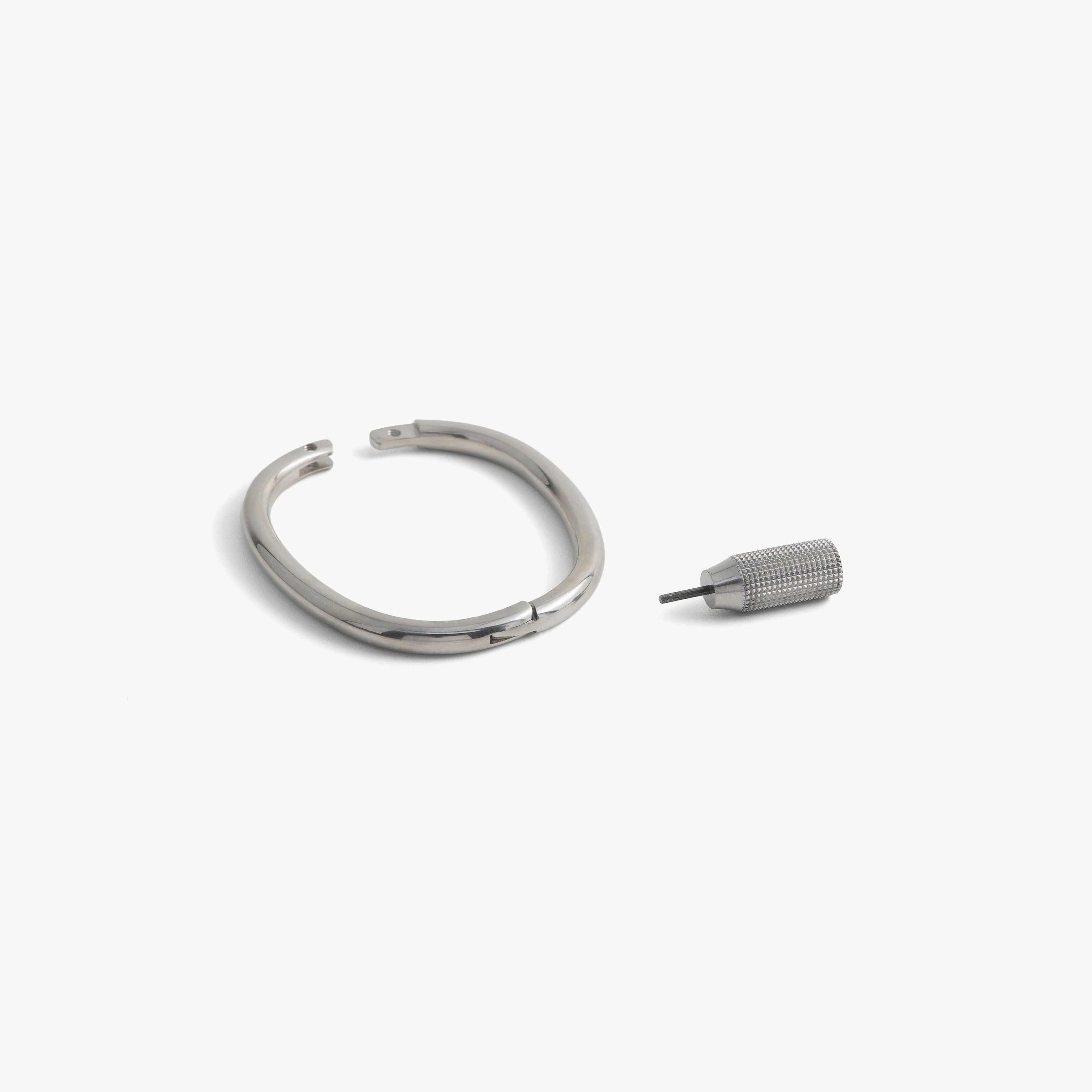 deSade silver wrist bracelet shown open beside its hex key tool