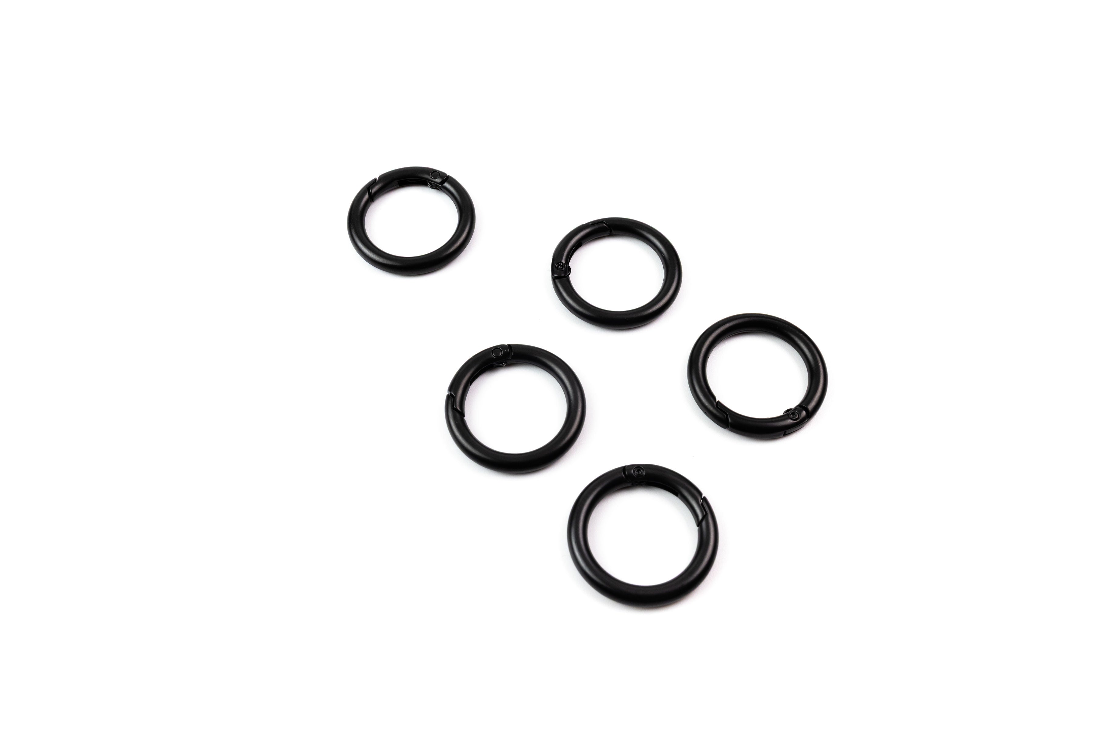 Five black o-rings on a white background