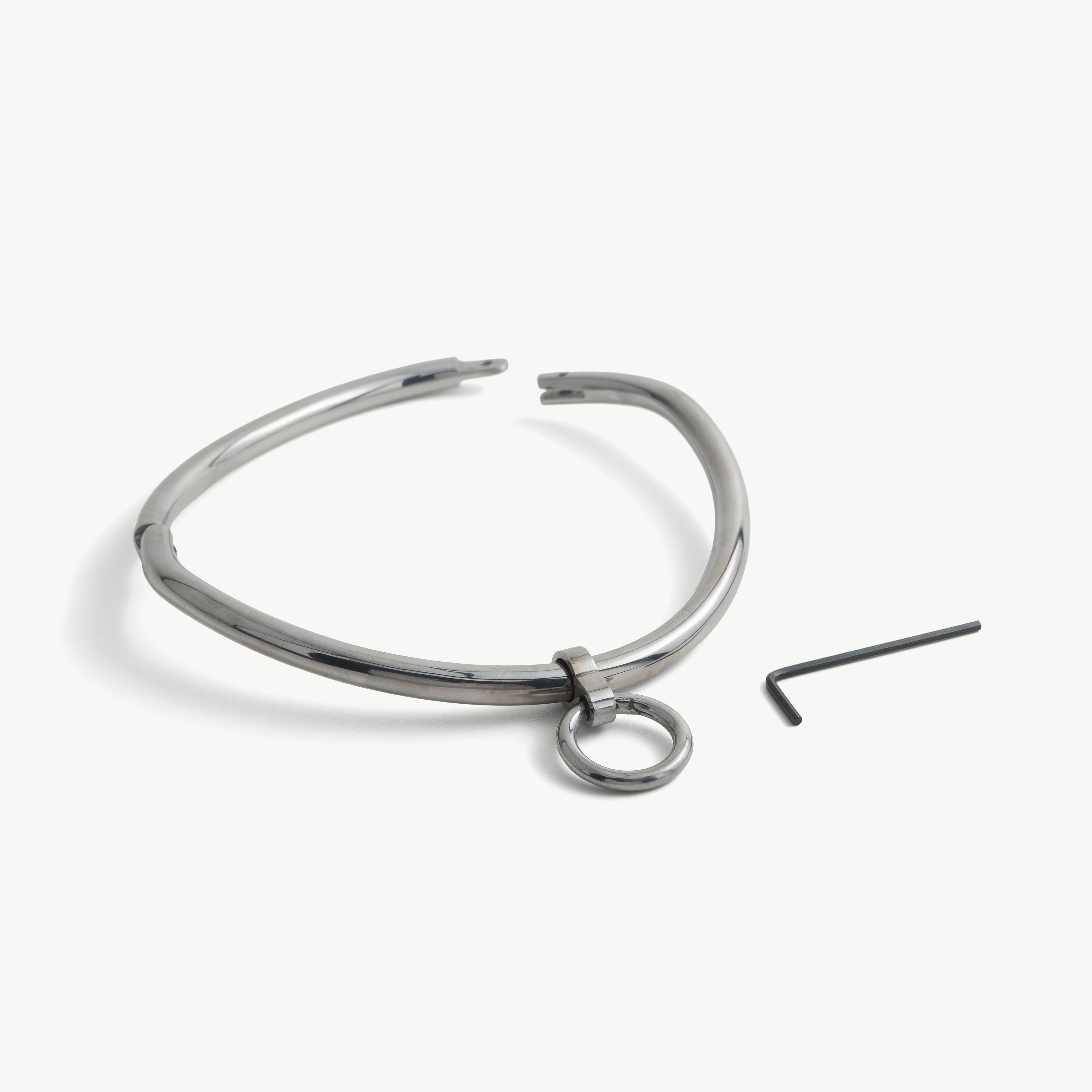 deSade silver day collar shown open beside its hex key