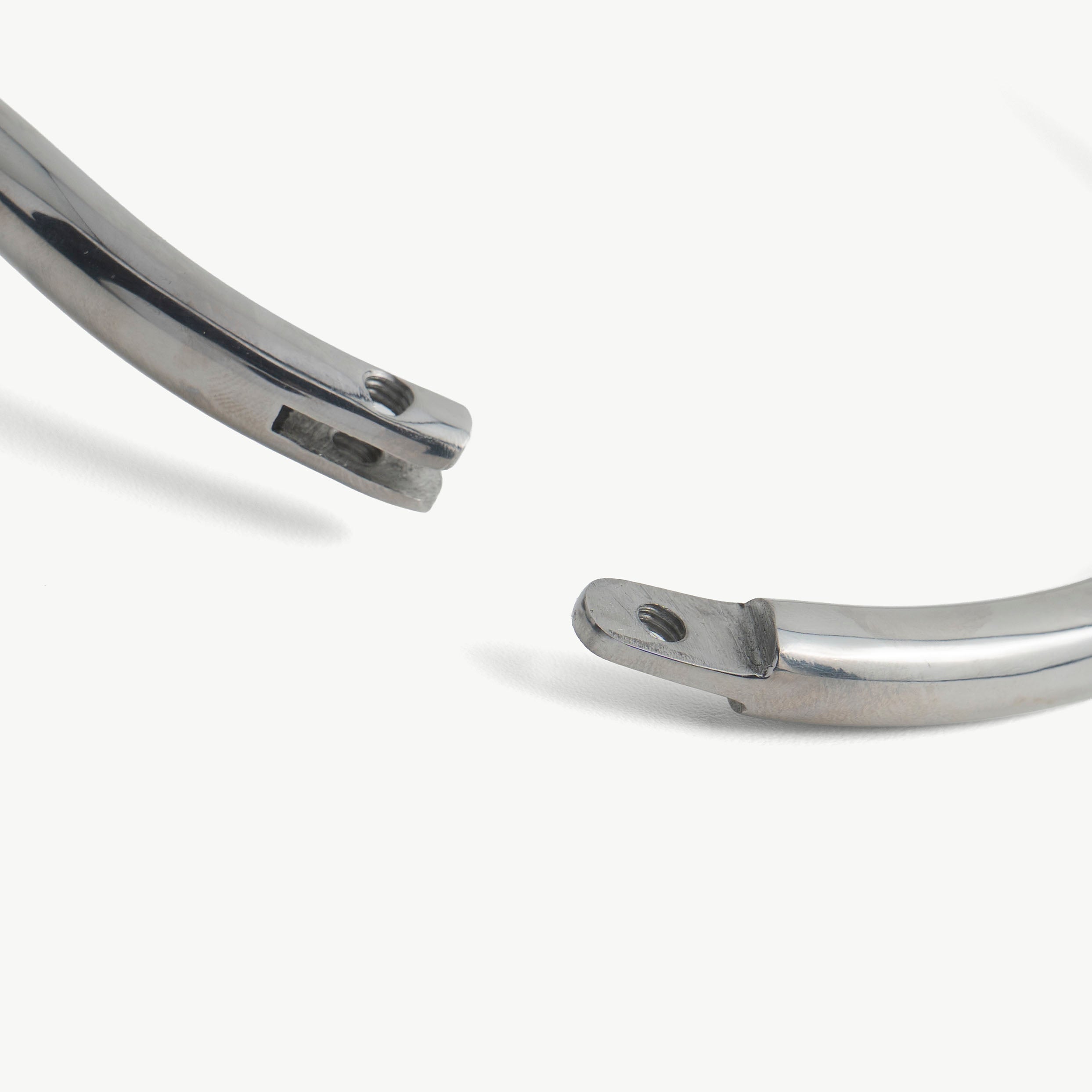 Close-up of the deSade collar's hex lock opening at the polished ends