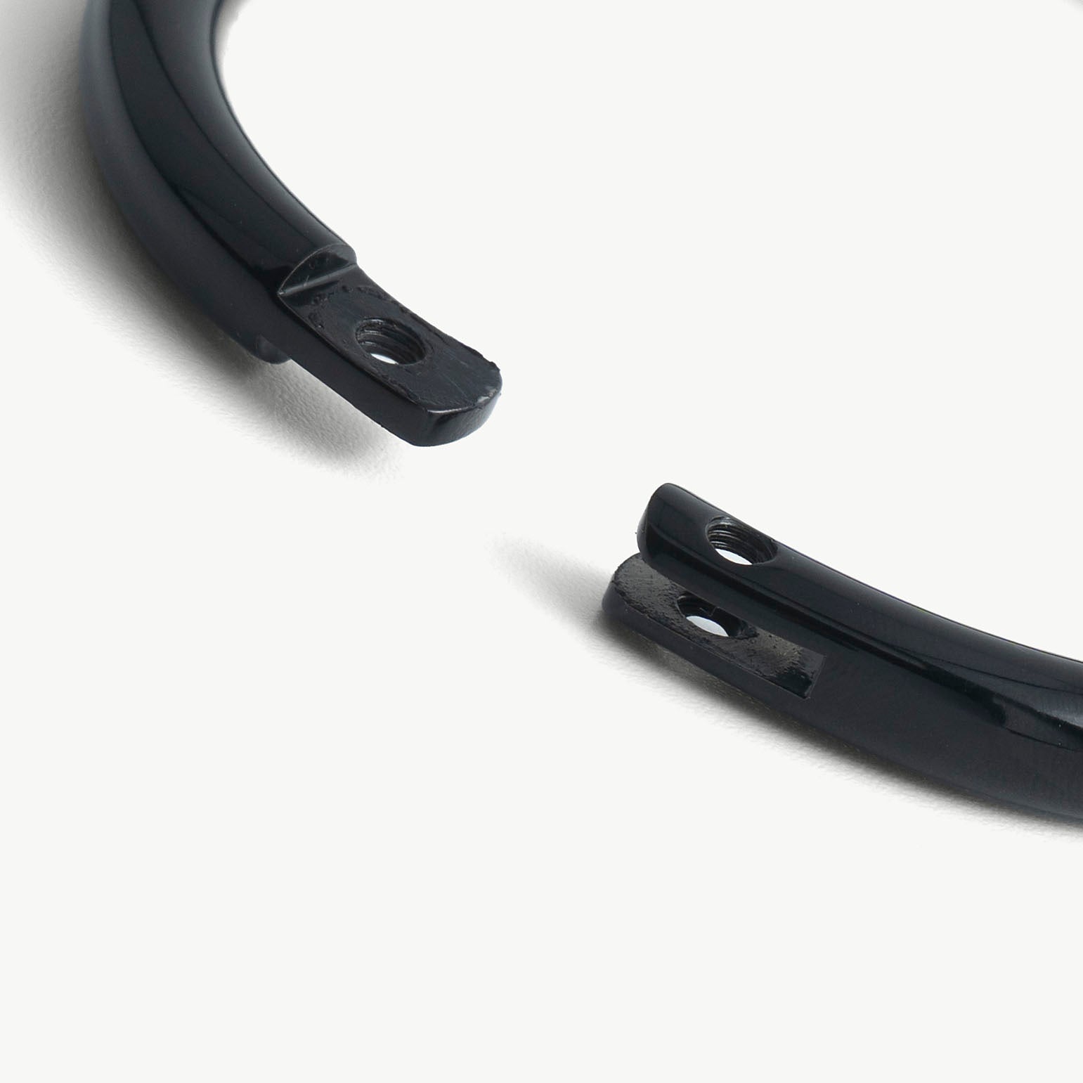 Extreme close-up of the deSade black bracelet's open ends and hex lock screw hole