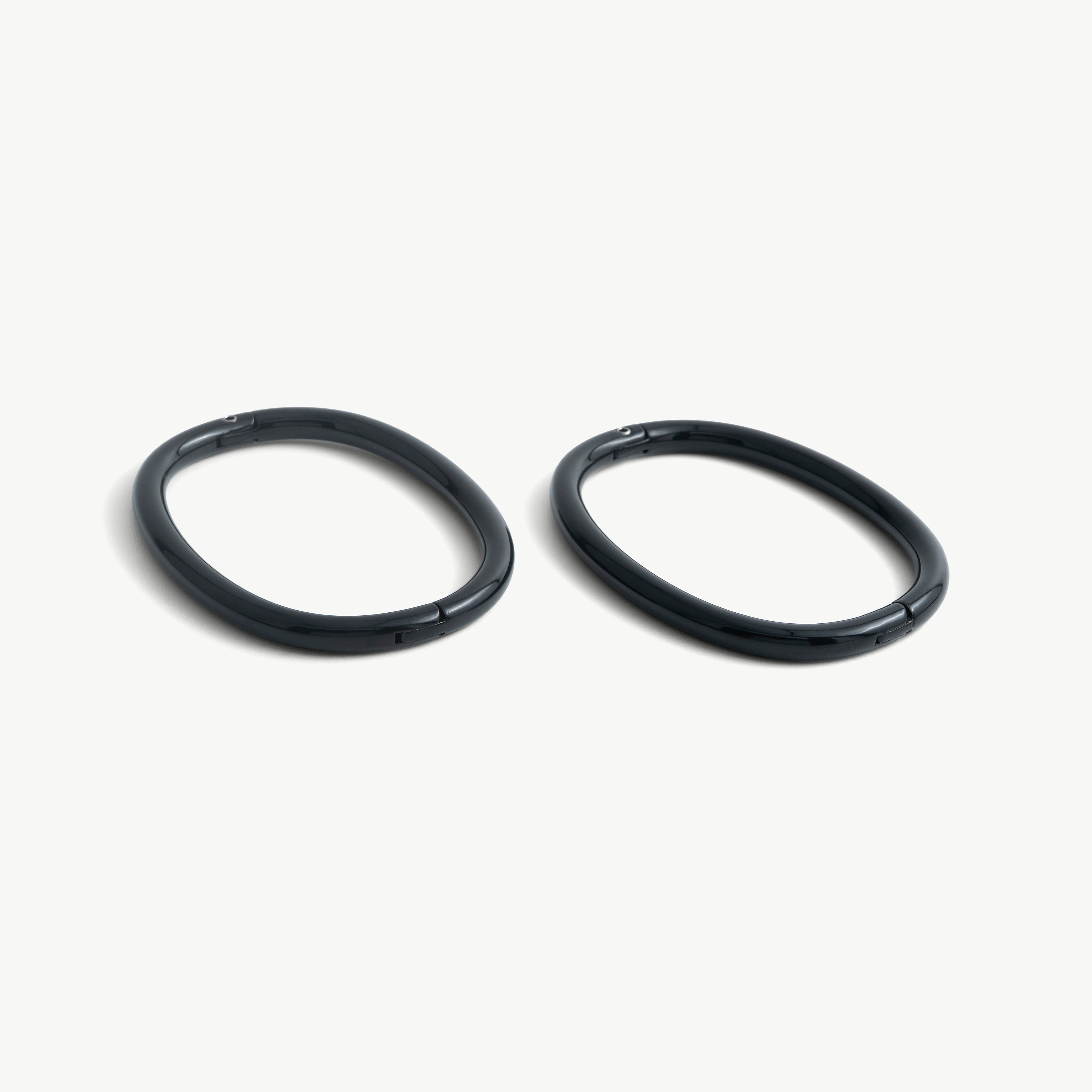 Pair of deSade black oval ankle bracelets shown together in 8mm steel
