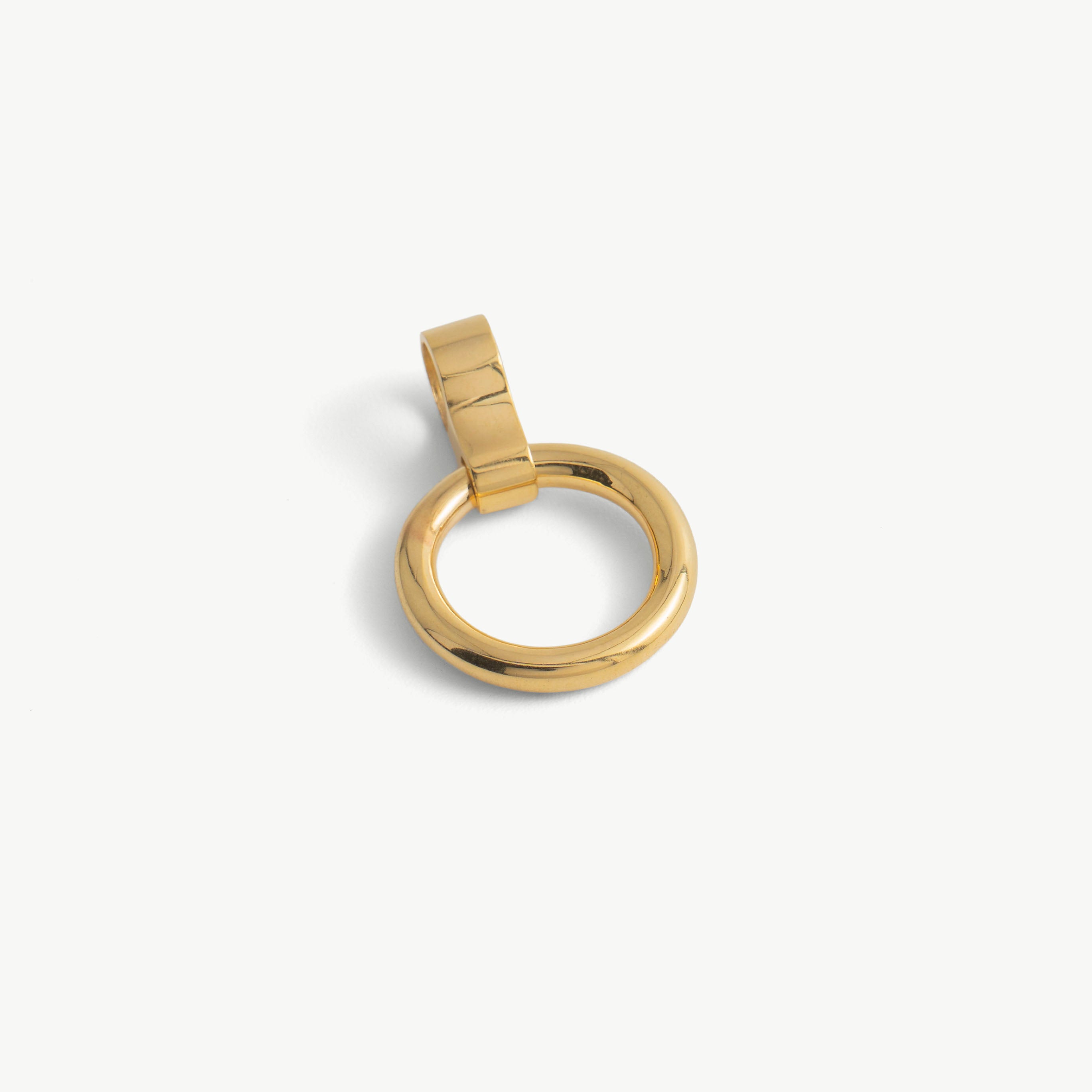 Close-up of a single gold O-ring pendant with its cylindrical slide-on loop