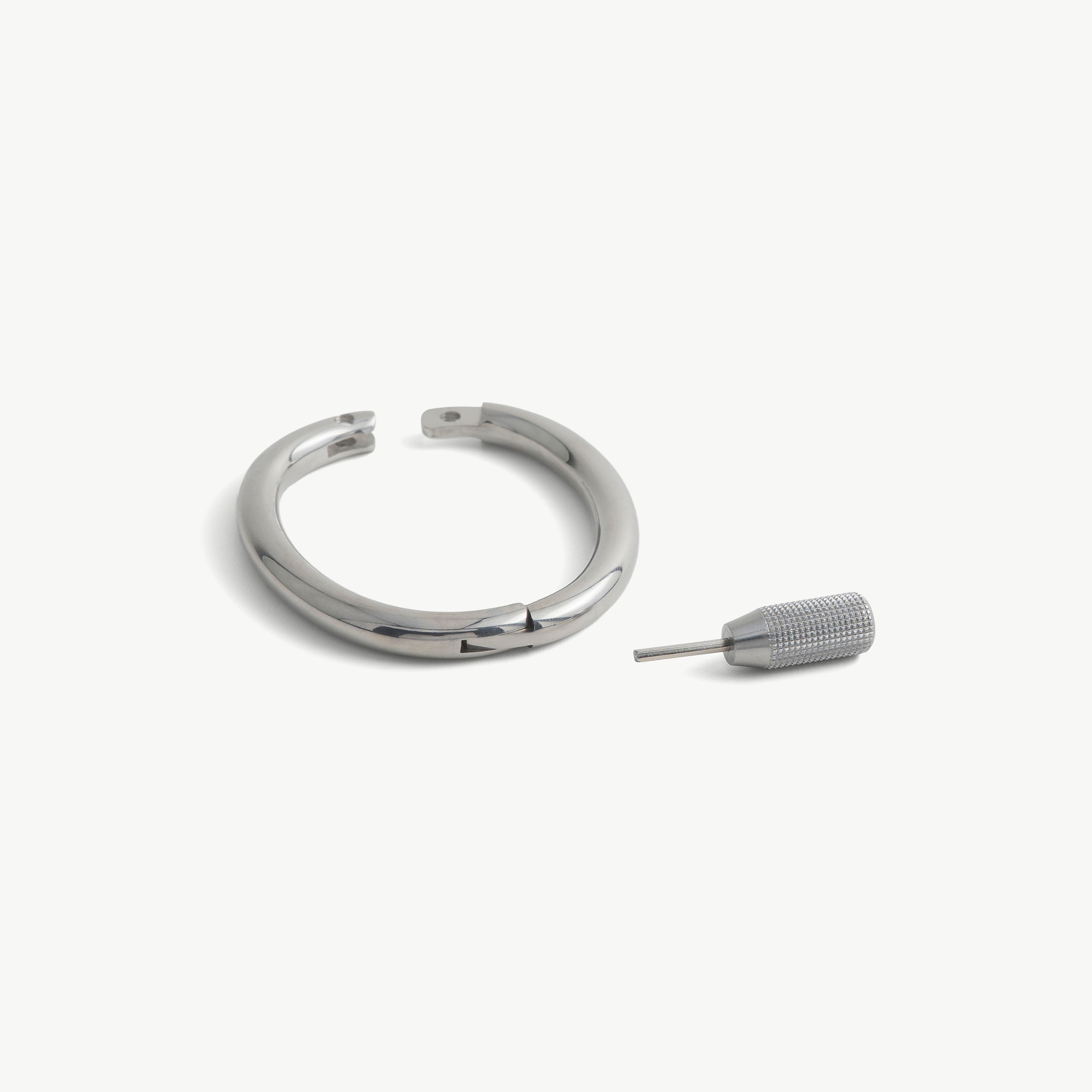 deSade silver wrist bracelet shown open beside its hex key tool