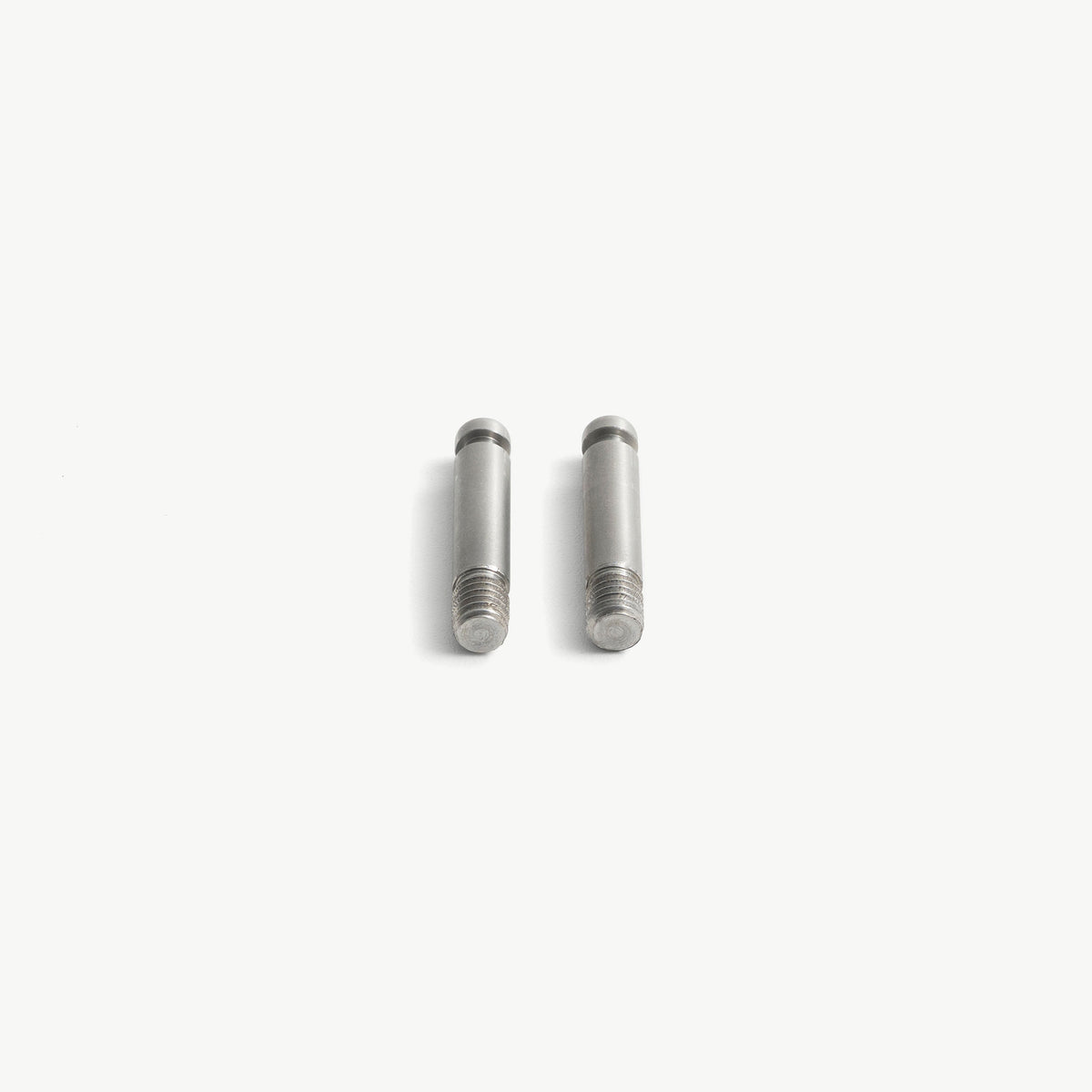 Set of two stainless steel medical lock pins, front view, showing the collared head and the M6 thread