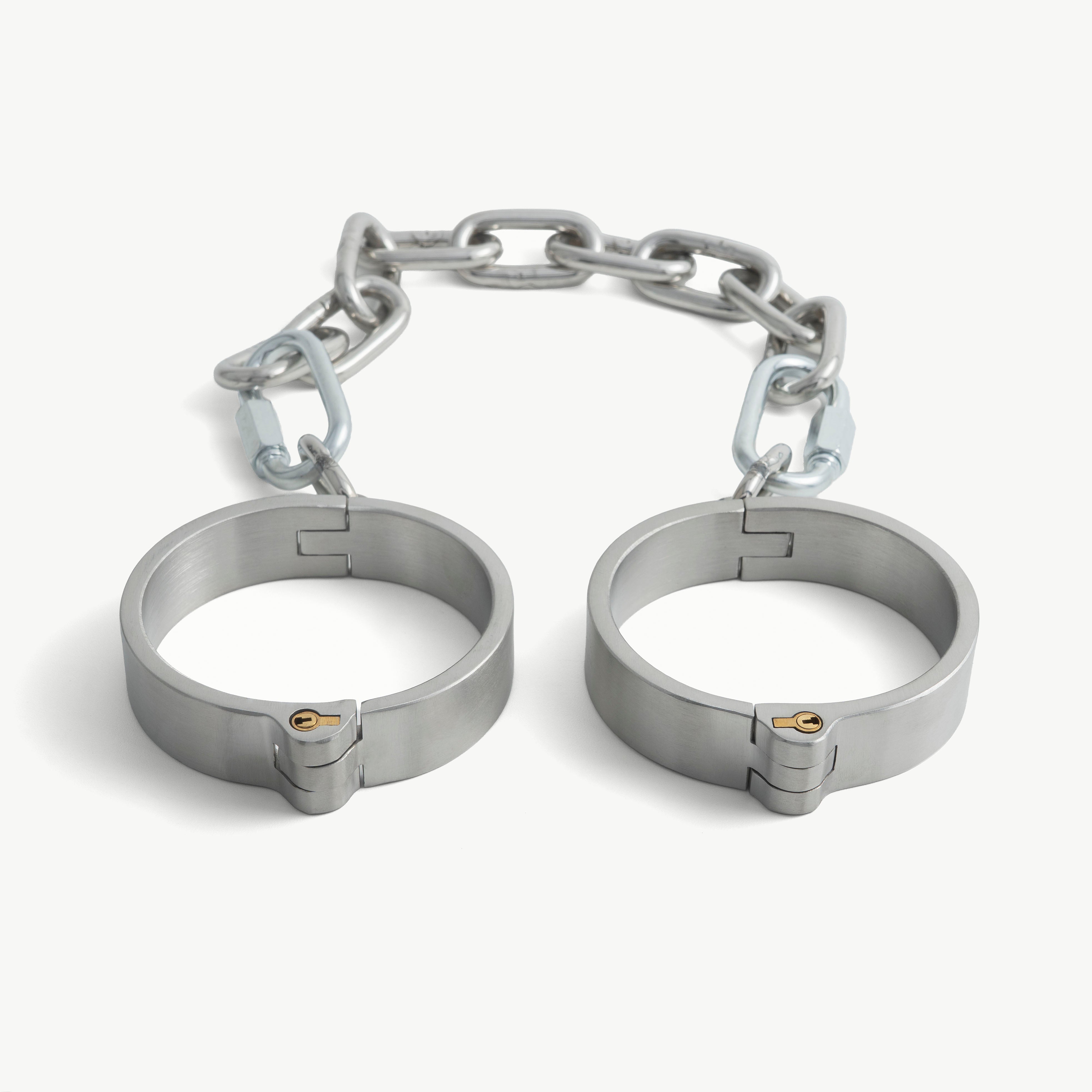 Brushed steel flat legcuffs seen from the front, showing the push-in lock band