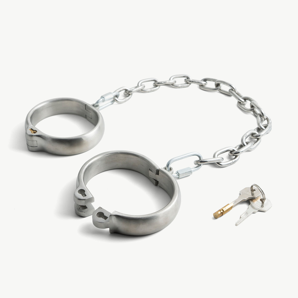 Rounded legcuffs shown open with the push-in lock and keys