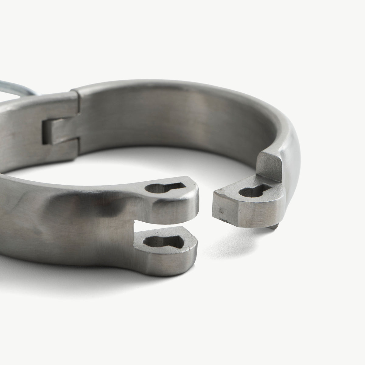 Close-up of the rounded legcuff's open hinge ends and lock slots