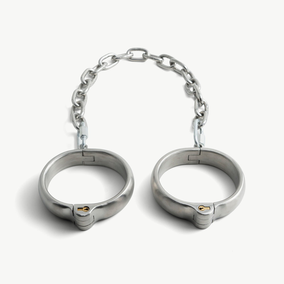 Rounded stainless steel legcuffs joined by a chain, front view