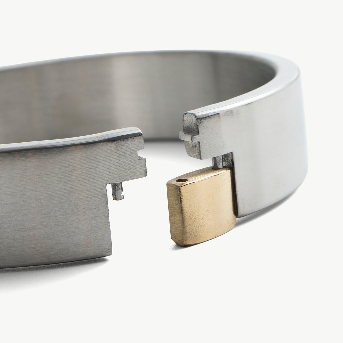 Close-up of the padlock collar's open ends with the brass padlock in place